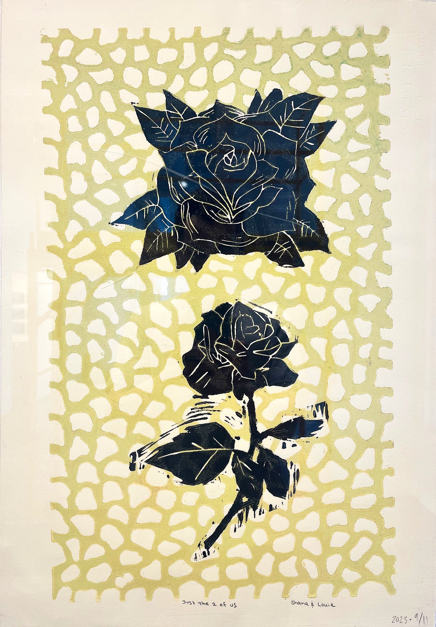 Several linoleum block prints layered on a piece of white paper. In the background, a greenish yellow lattice that resembles creeping, interlocking vines. Printed over top of this lattice are two black roses. The top rose is large bloom surrounded by leaves, and the bottom rose is smaller with a long leafy stem. The work is a collaboration between two artists, and has been signed and dated in pencil along the bottom border.