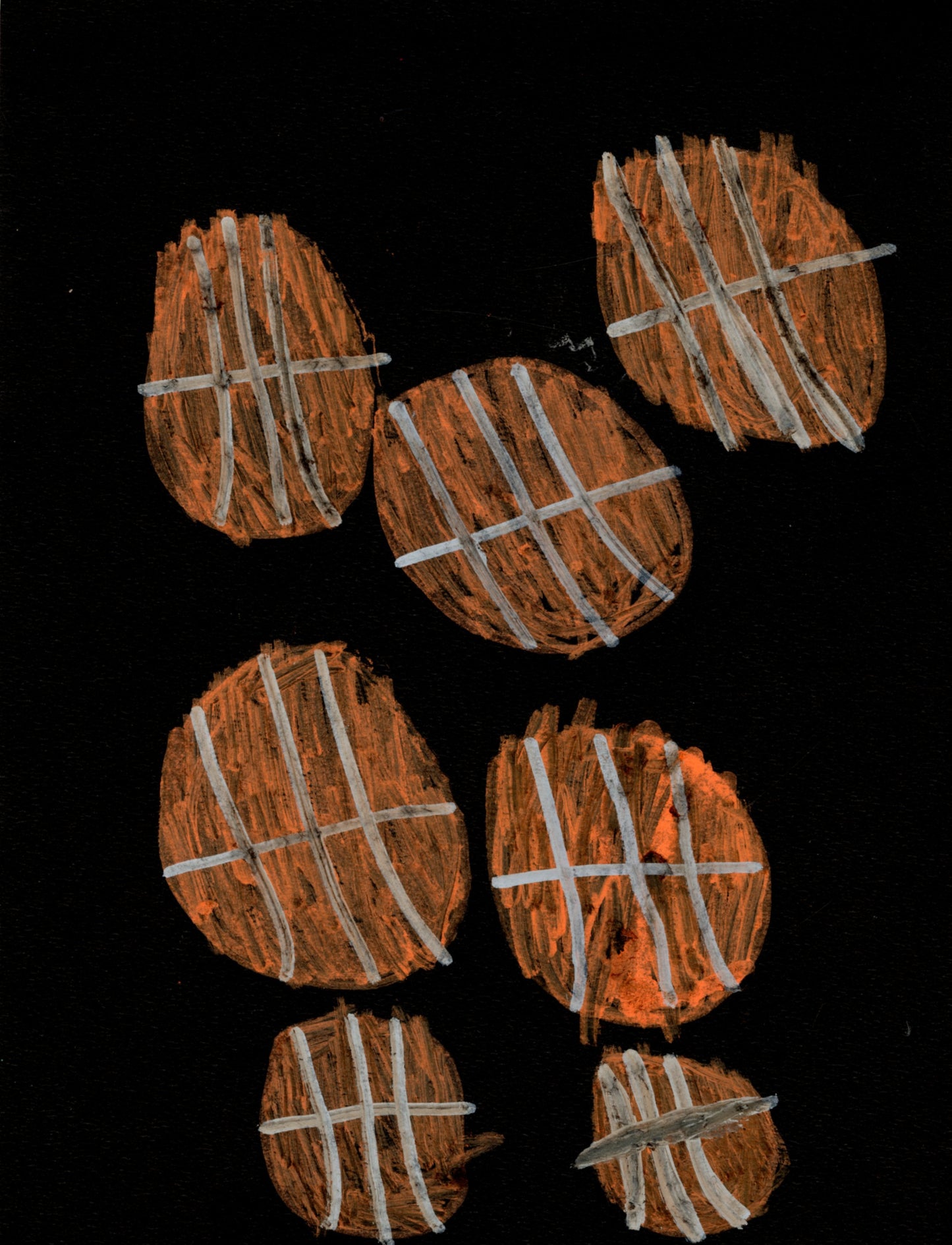 Seven basketballs against a black background.