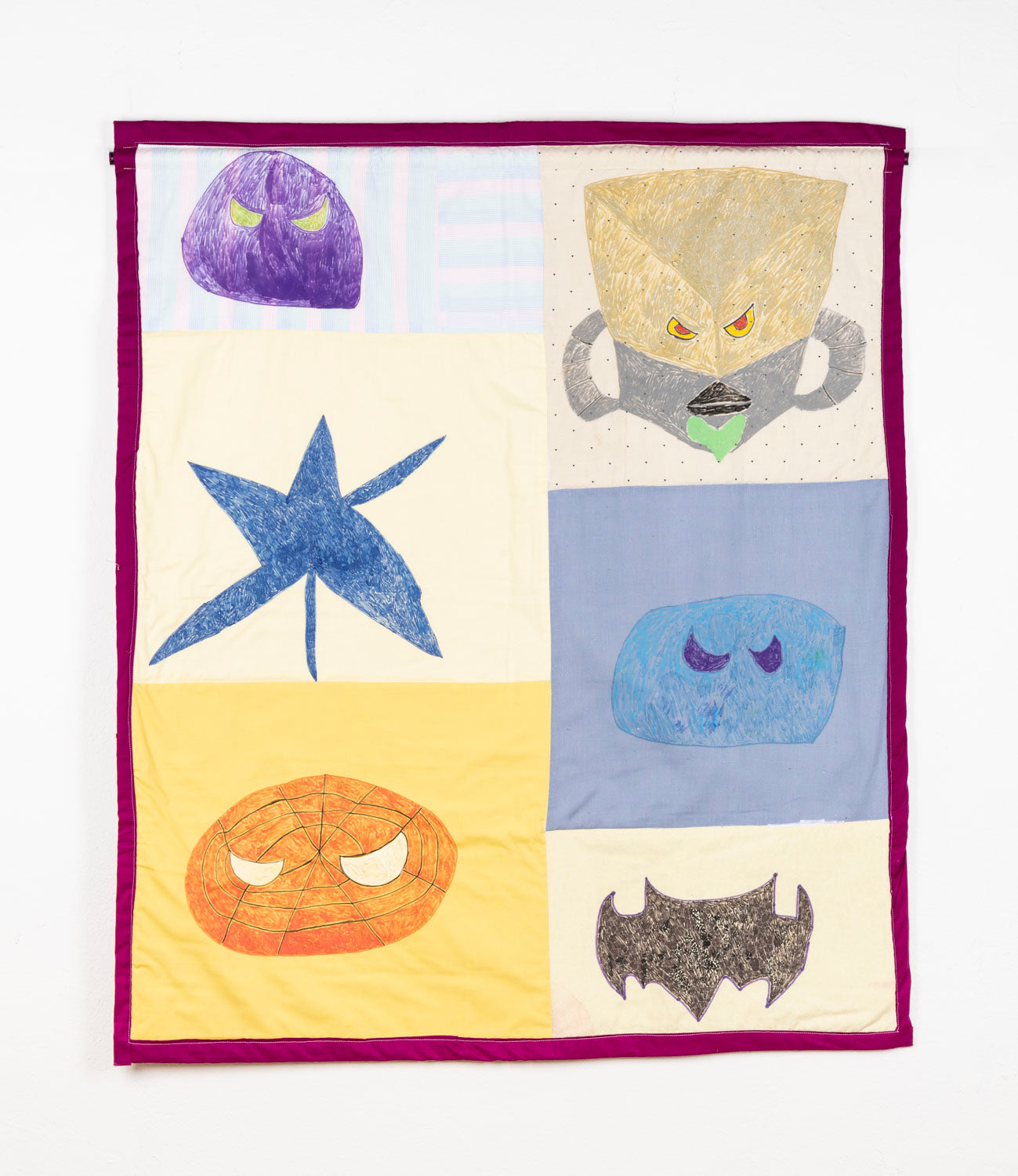 This fabric piece has a magenta border, and has 6 figurative elements, with three on the left and three on the right. The figurative elements are all contained in different coloured boxes.