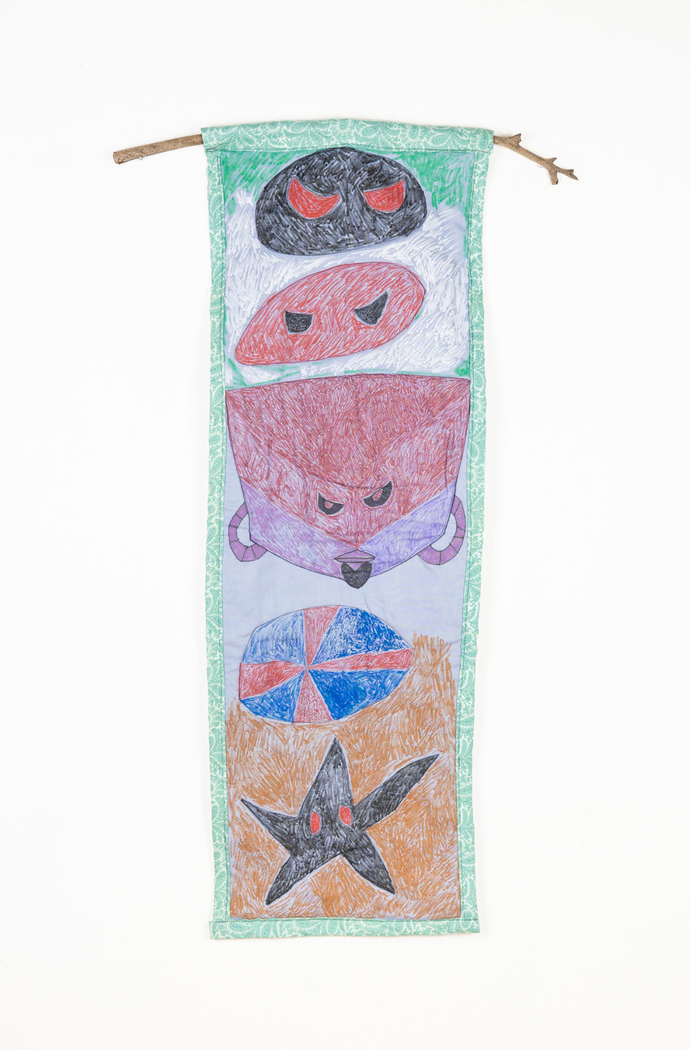 This fabric piece is hanging on found wooden stick. The piece is predominantly green, and has 5 figurative elements that are in a vertical line.