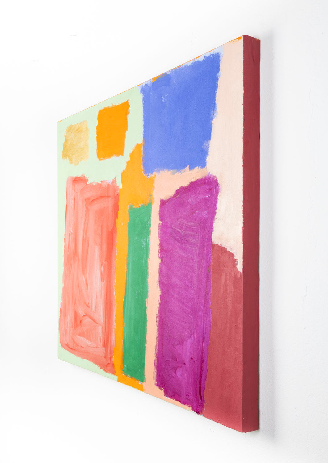 This abstract painting has a blocky quality, containing rectangles of different colors and sizes that are overlapping. The piece is orange, beige, blue, red and green; all the colors are vibrant which provide a strong sense of contrast. The artists' hand is prevalent in the piece, shown through clear brushstrokes.