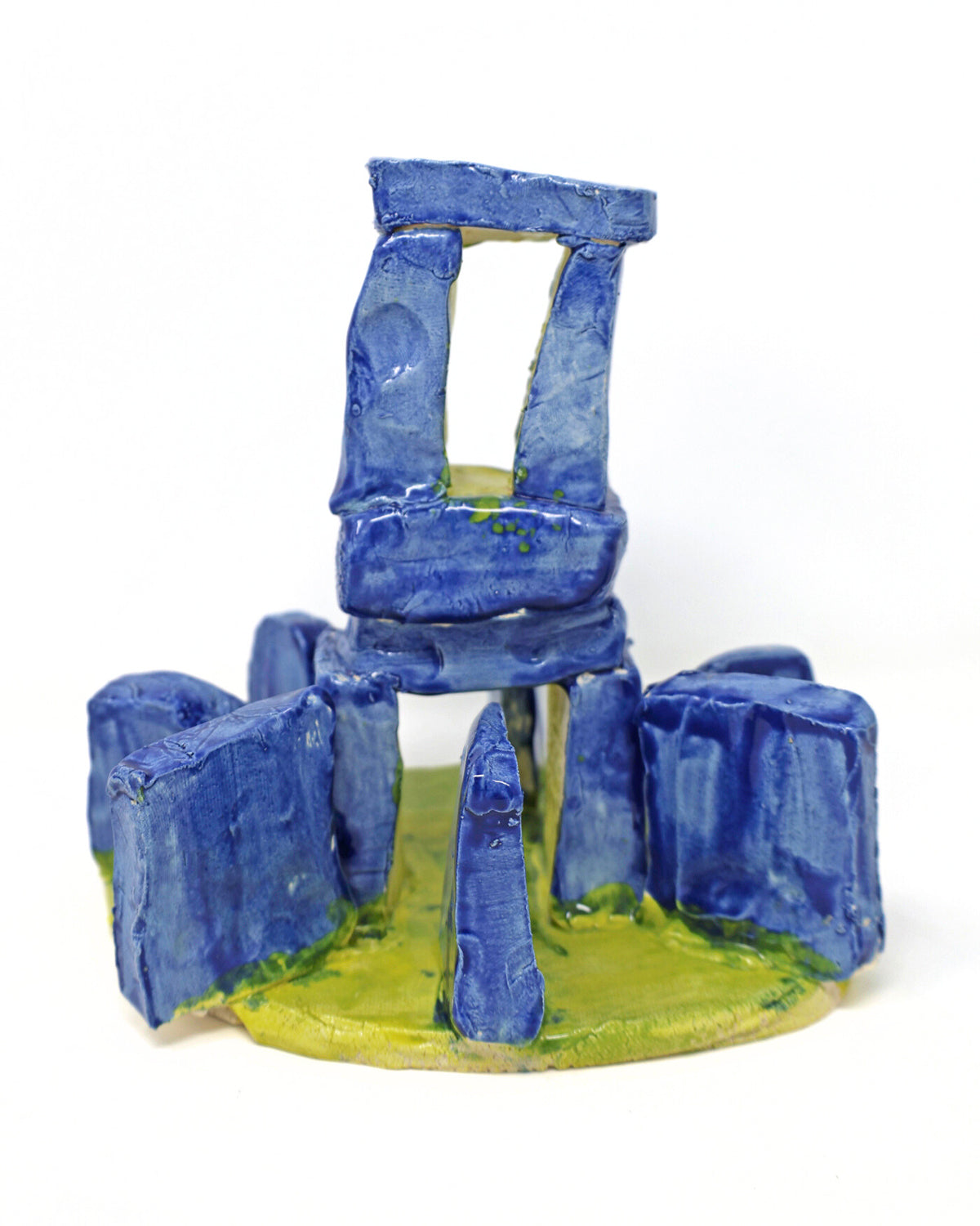 A ceramic architectural structure resembling Stonehenge in blue with a green base.