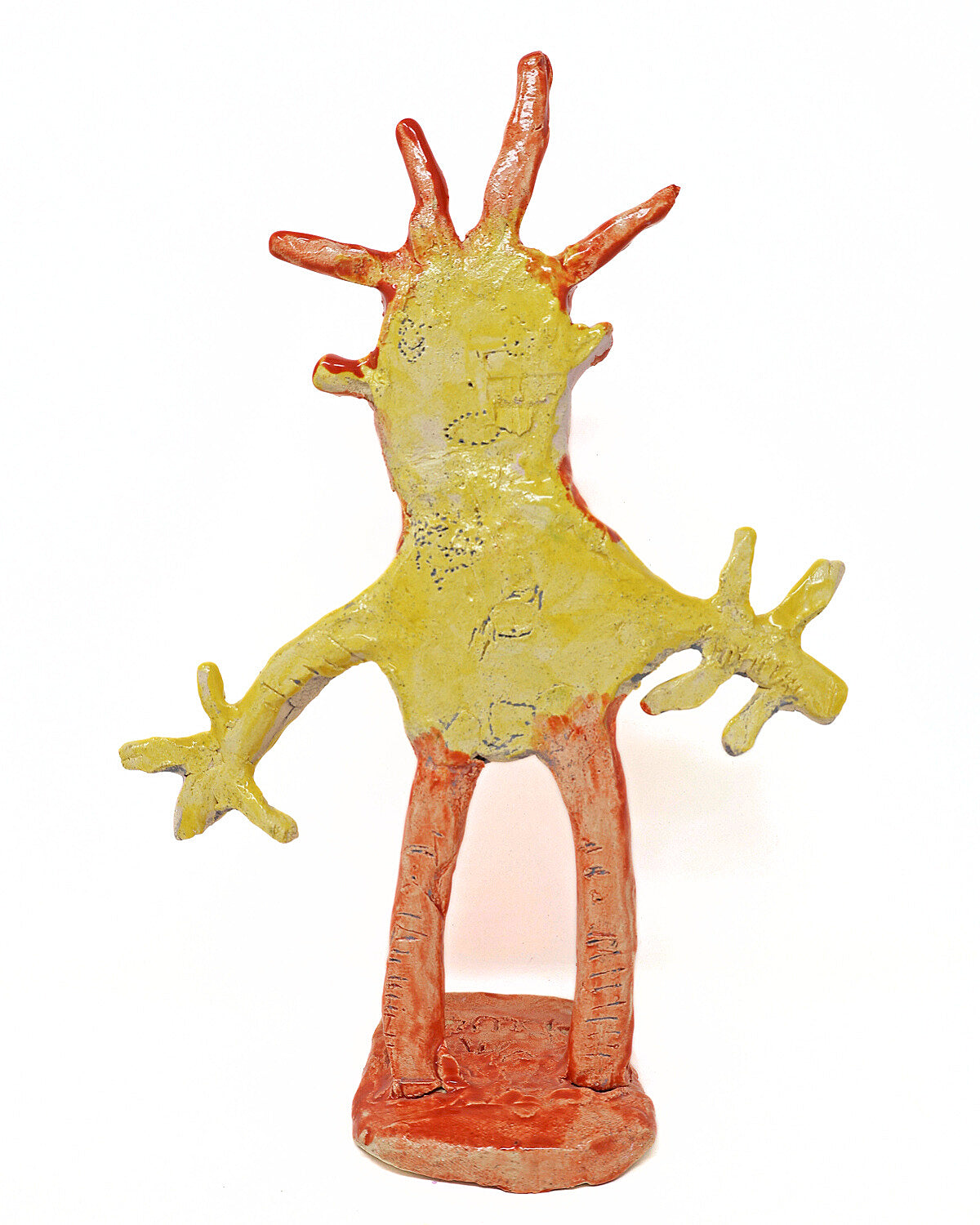 Abstract ceramic sculpture with orange and yellow colors against a white background