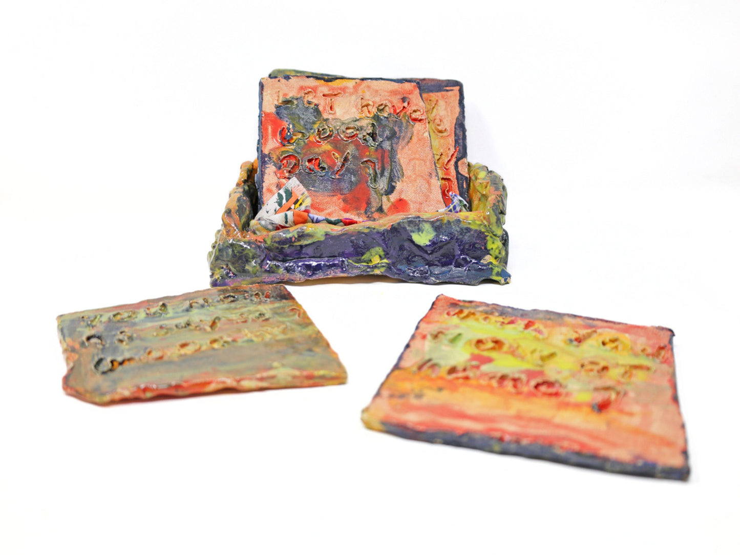 This ceramic sculpture has a base with five removable tablets. Text is carved onto both sides of the removable tablets, and are glazed with pink purple and yellow glaze.