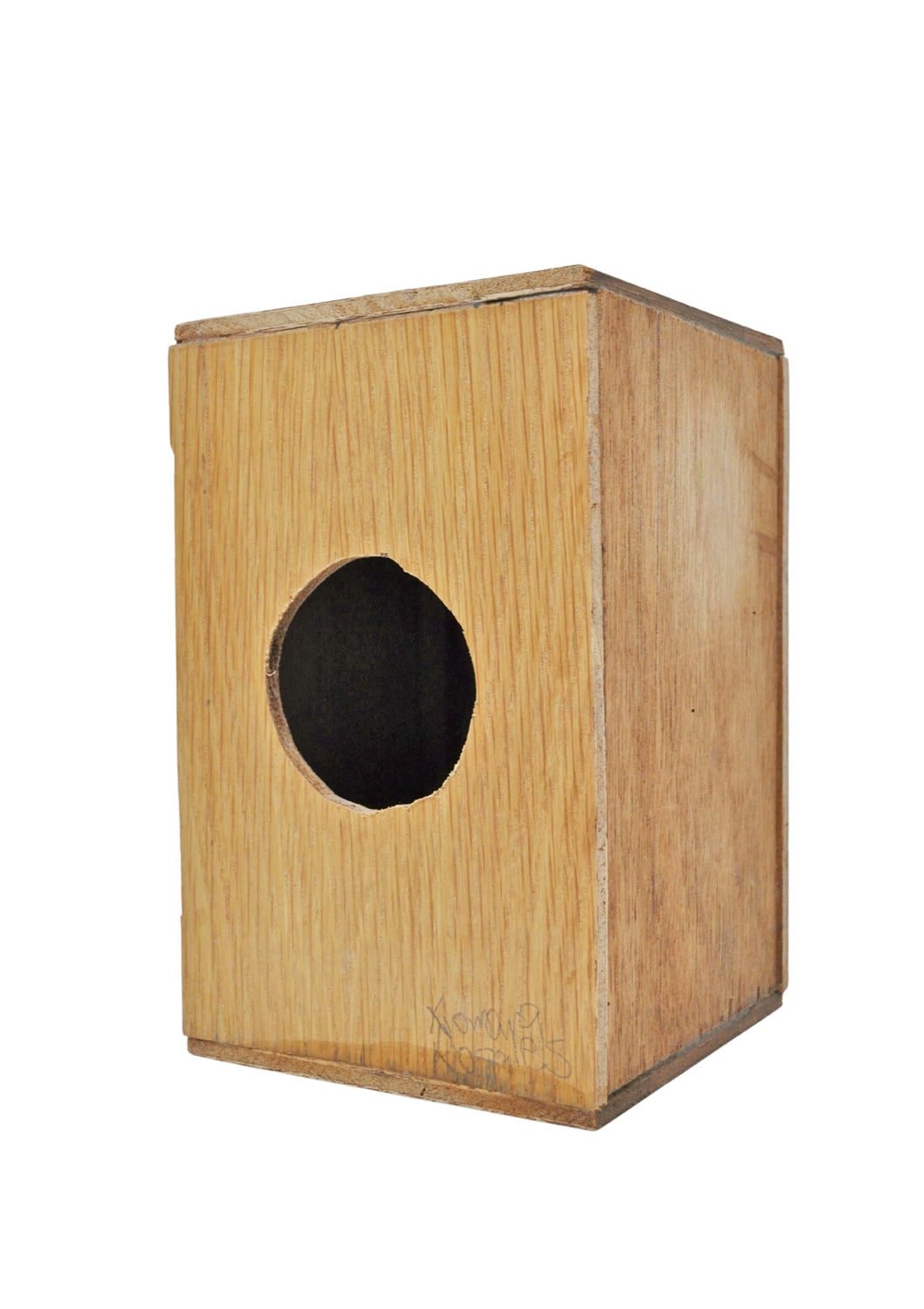 The backside of a wooden cajon, a Peruvian hand drum, with a natural brown finish, photographed against a white background.