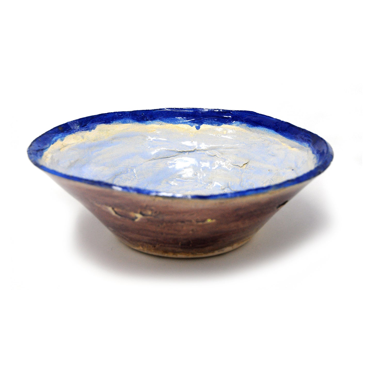 A wide ceramic bowl glazed purple on the exterior surface, and blue and green on the inside of the bowl.