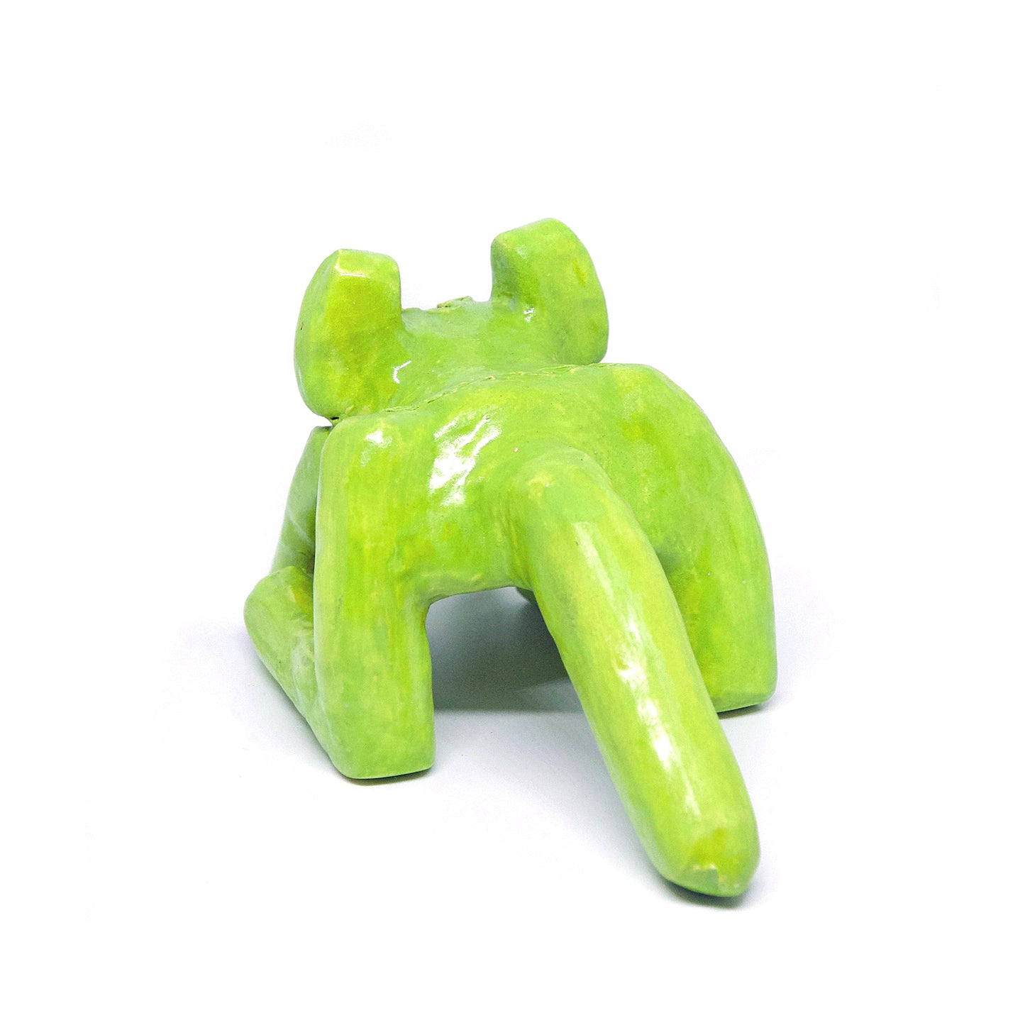 The same ceramic sculpture of a mouse or kangaroo, viewed from the back. The creature has a long tail, and is hunched forward. The entire sculpture is glazed a bright leafy green. Symbols are etched onto its haunches.