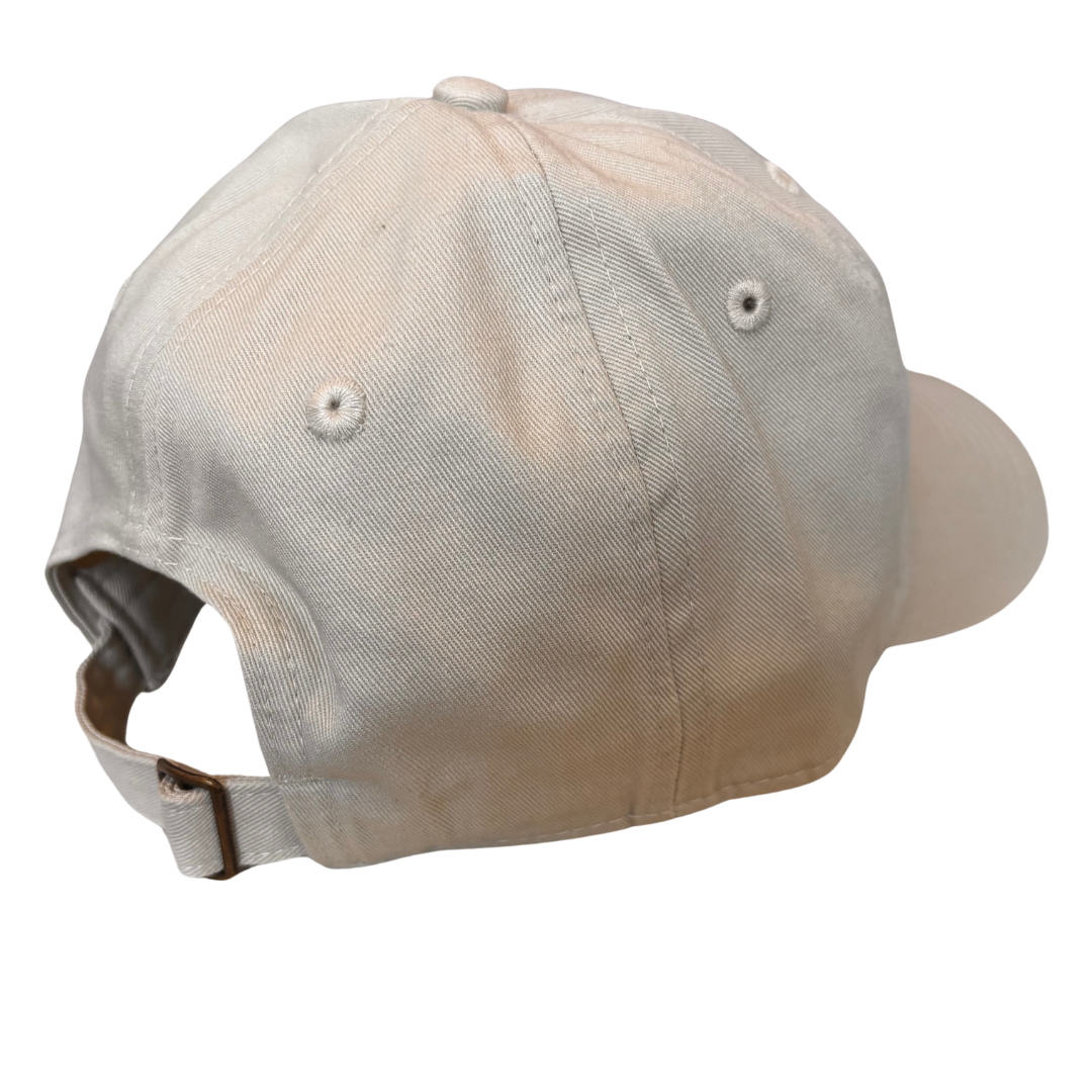 The back of the baseball hat, with a brass back buckle. The hat floats in a white void.