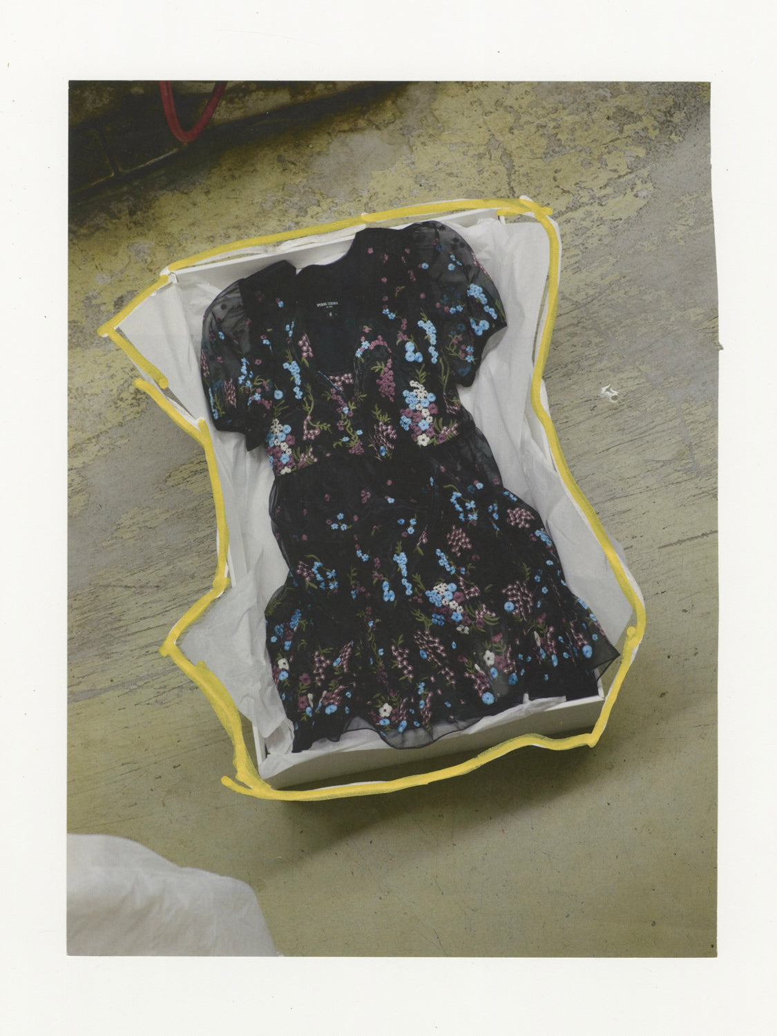 This mixed media piece contains an image of a dress at Madame Paulette. The dress is diagonally framed in center of the image, and the dress bag is outlined boldly in gold. 