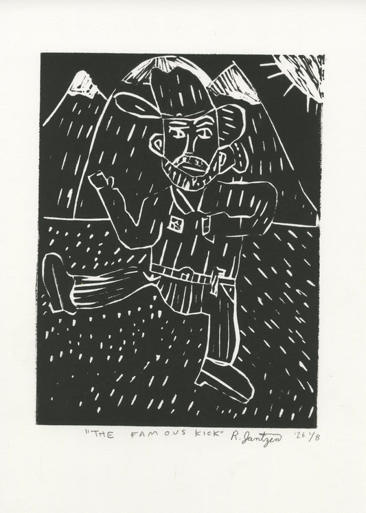 This is a linocut print on paper with black ink. The image printed depicts a figure kicking out one leg. The figure is wearing a western outfit, including a cowboy hat, a button down and a belt. In the background is a mountain scene, with the sun in the top right corner.