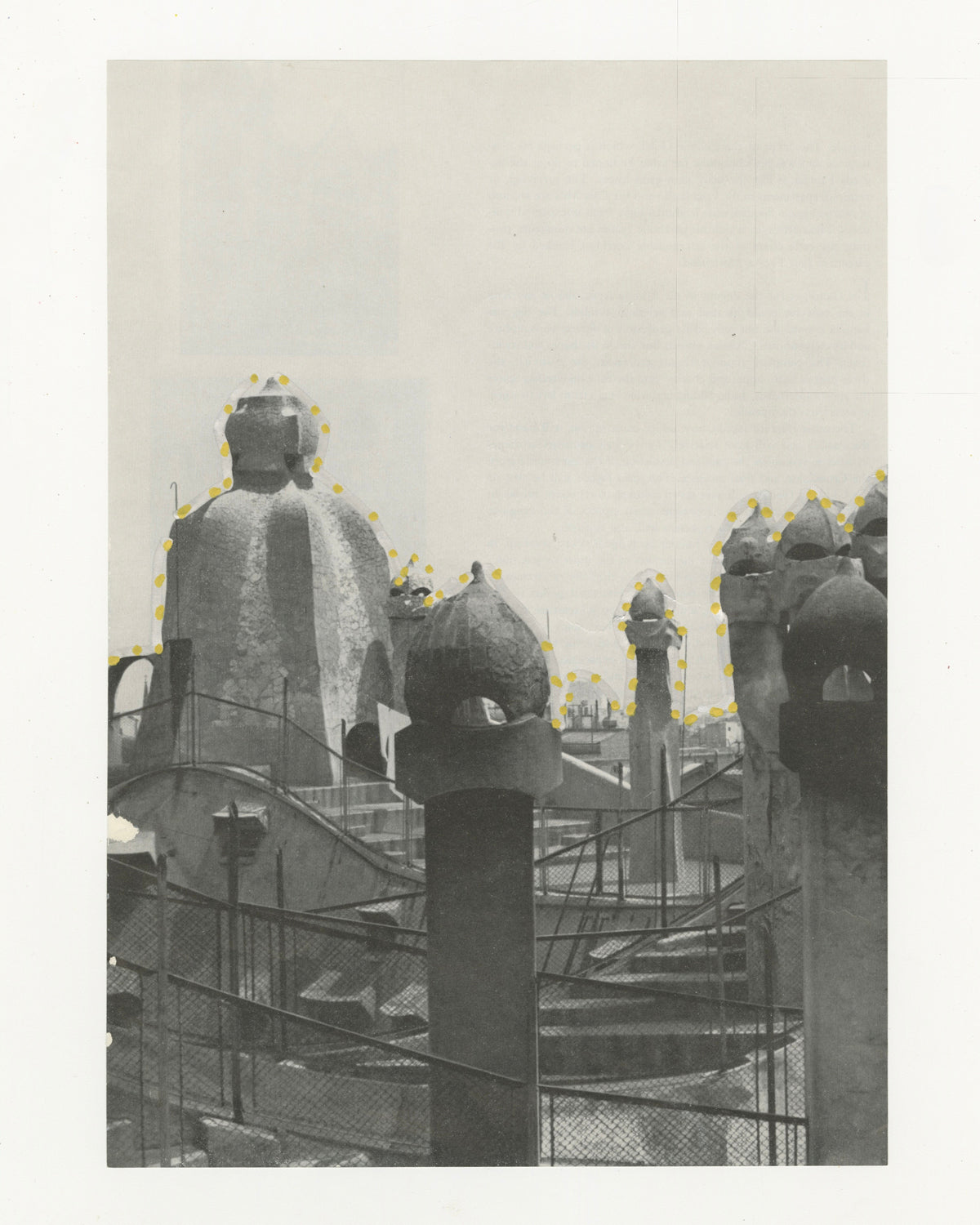 This mixed media piece incorporates gold and grey elements on a found magazine page. The magazine page contains a photograph of Casa Mila in Spain. The structure is outlined in grey, along with gold dots.