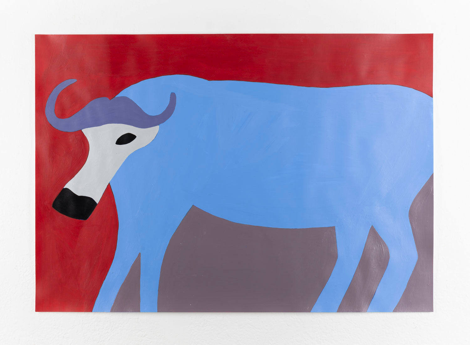 A stylized, abstract depiction of a buffalo. The body of the buffalo is painted in a flat, vibrant blue, contrasting against a deep red background. It is depicted shown in profile view, with a distinctively curved, purple horn and a black snout. The animal's neck and part of its face are colored in off-white, while the eye is a bold black oval. The legs and underbelly share a muted grayish-purple tone, adding to the abstraction. The composition is simple, with clean lines and solid patches of color.