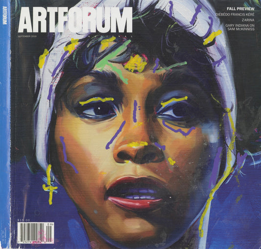 Magazine cover of Artforum with a stylized close-up portrait of Whitney Houston's face. Yellow, purple, and green marks highlight different parts of her face. 