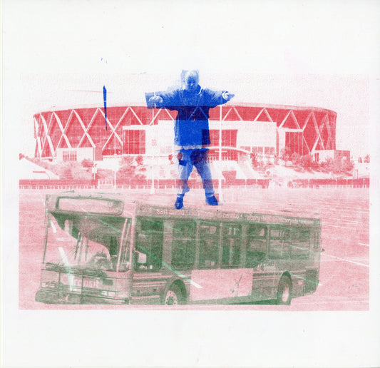 A digitally manipulated scene with three distinct elements. In the background, there's a large arena with a red and white facade featuring a geometric pattern, resembling a series of diamond shapes. In the foreground, a green-tinted bus is superimposed, displaying a partial image of its front and side, with "AC Transit" visible. Central to the composition is a blue-colored figure standing atop the bus with outstretched arms, dressed in a winter coat.