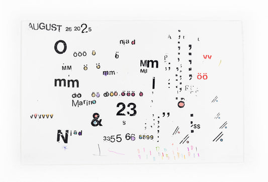 A piece featuring a scattered assortment of letters, numbers, and symbols in various fonts, sizes, and colors, all set against a plain white background. At the top left, the word "August" is prominently displayed in a bold, black font, followed by smaller numbers "26 20 2.5". Throughout the image, there are various instances of the letter "o" with umlauts in different sizes and colors, alongside other letters like "mm", "Mm", and a larger "Niad" with some letters in a rainbow hue. 