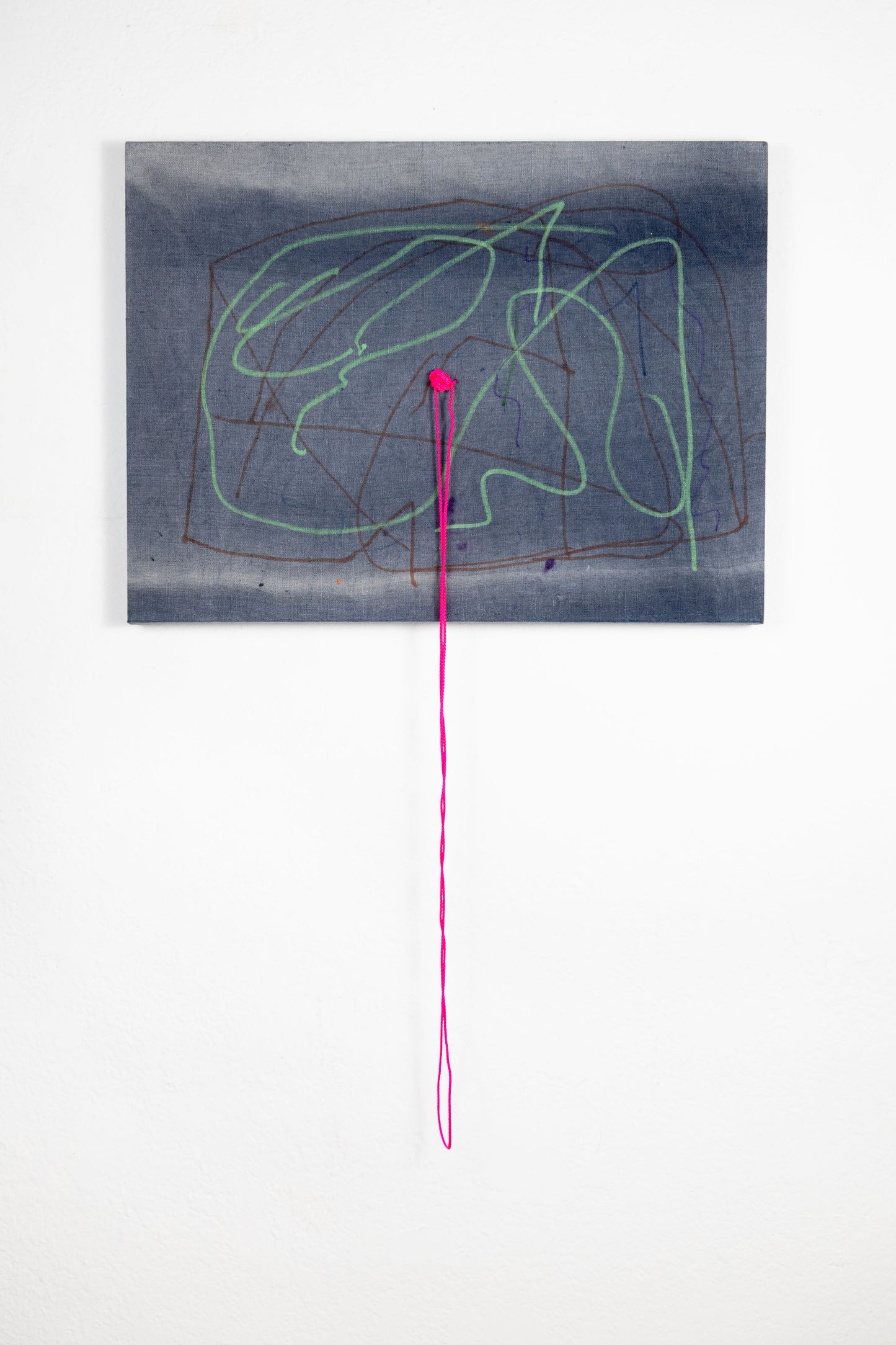  A rectangle artwork on stretched gray fabric that has been sun bleached. There are green and burgundy acrylic marker squiggle lines throughout. In the middle of the artwork, a neon pink string has been knotted and strung through, and hangs loose a few inches below the artwork.