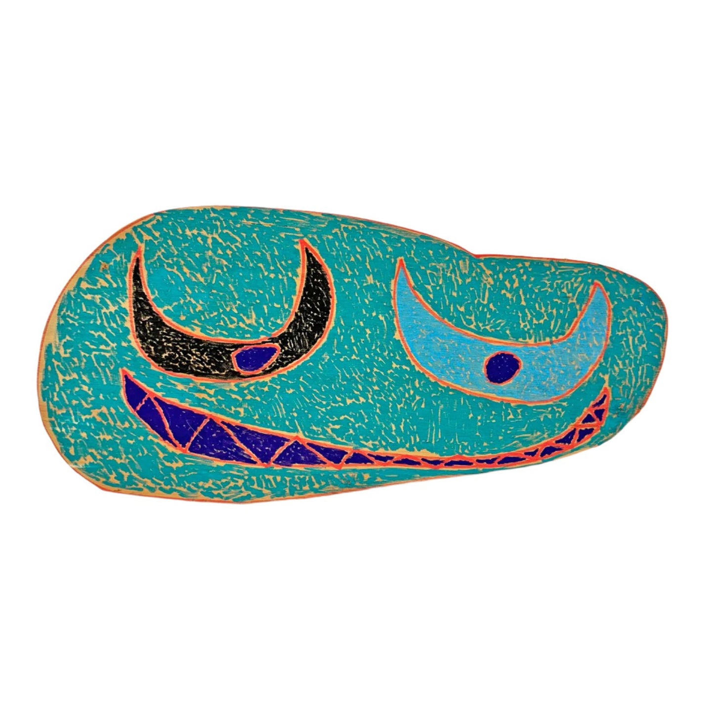 An oblong oval shape of wood, photographed on a white backdrop. The wood has been colored with blue, black, and red paint marker, with designs that make it appear to have a face: two crescent moon-shaped eyes and a long smiling mouth. The eyes are colored black or blue, with dark blue pupils. The mouth is dark blue with pointed teeth outlined in red. The surface of the wood shape is filled with short turquoise dashed marks.