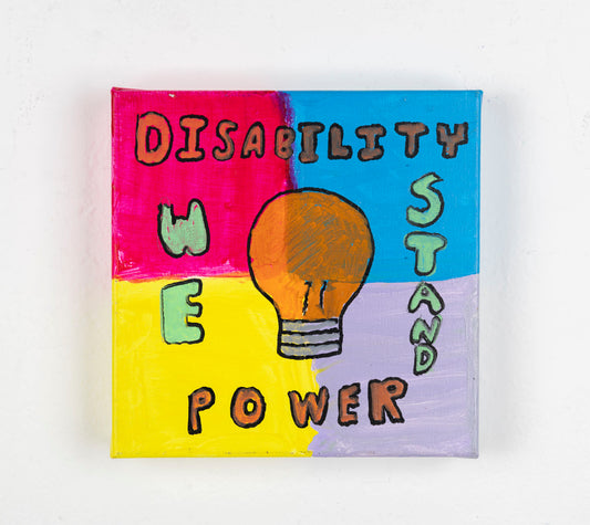 This painting is divided into four quadrants, distinguished through color; pink, yellow, blue and purple. The piece has the text 'Disability power' which is an orange color, outlined in black. The text 'We Stand' is green, outlined in black. In the center of the painting, there is an orange lightbulb which is also outlined in black.