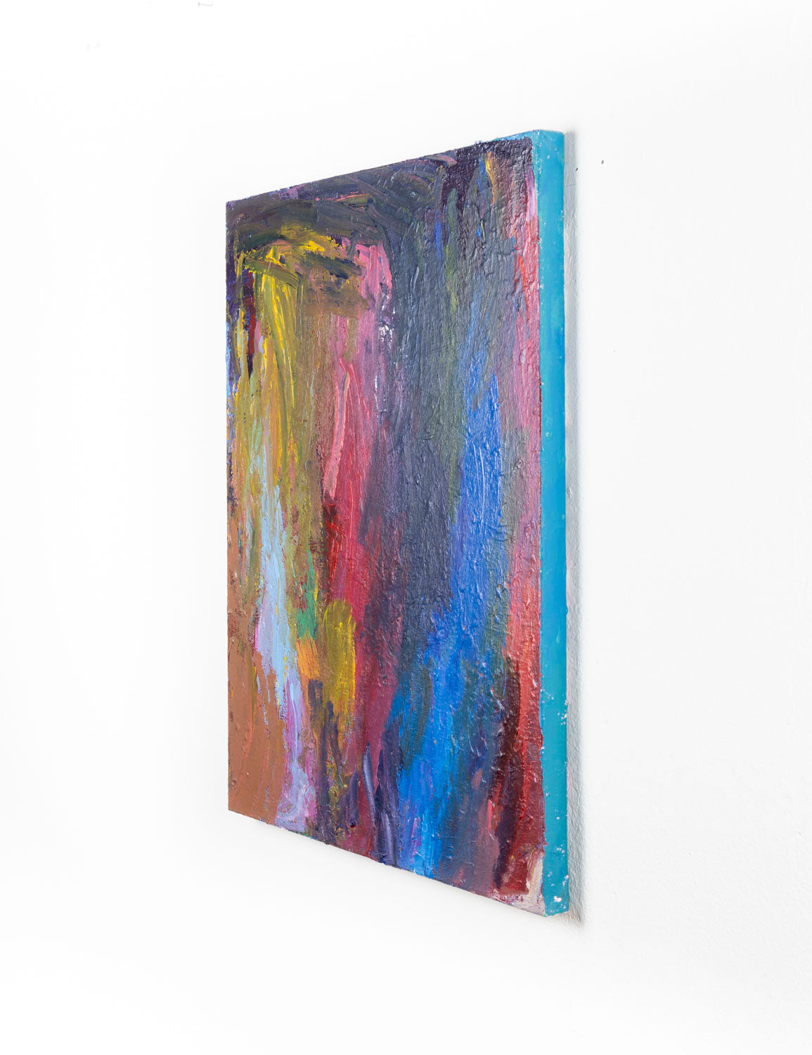 This abstract painting contains gestural mark-making, with a multi-colored palette of varying shades of blue, red, yellow and orange. The artist's hand is highlighted through bold bush strokes.