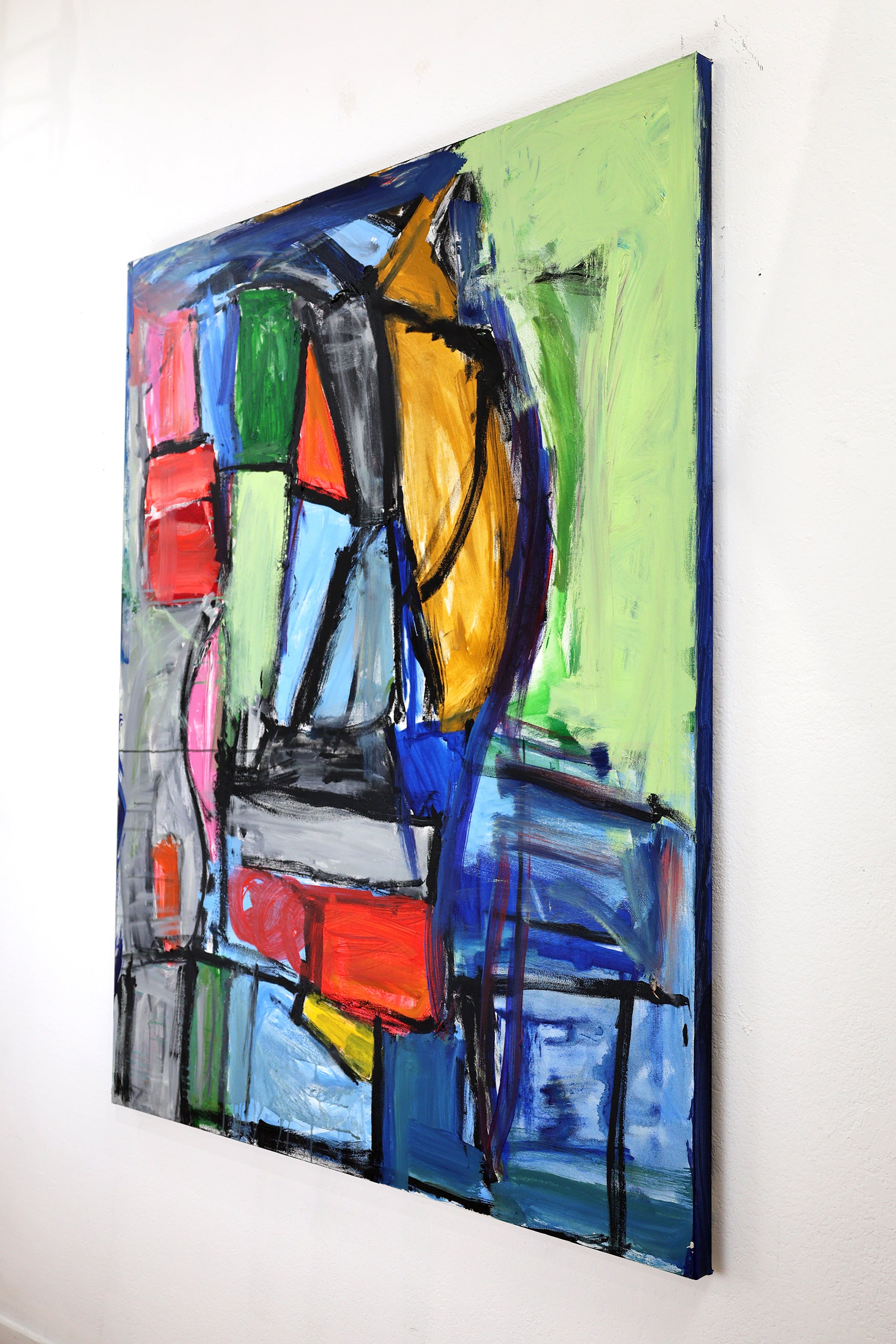 The same painting photographed from the side to show the thin dimensions. The side of the canvas is painted blue. 