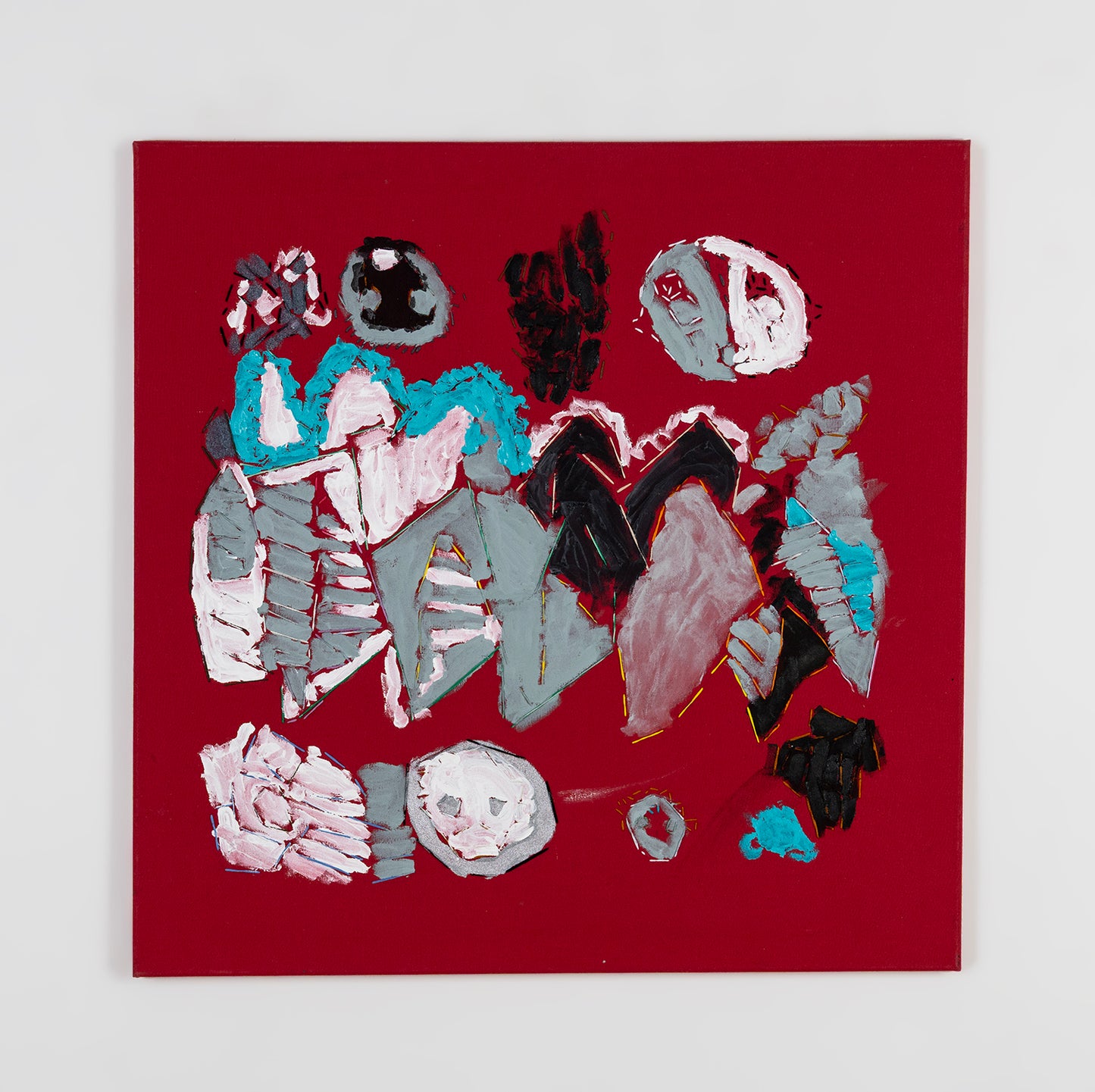 A mixed media painting on stretched red fabric. A cluster of diamond and rounded shapes fit together in the middle of the fabric, each painted a shade of grey, white, or bright blue. Some of the painted shapes are outlined with yellow or green stitched embroidery thread. 