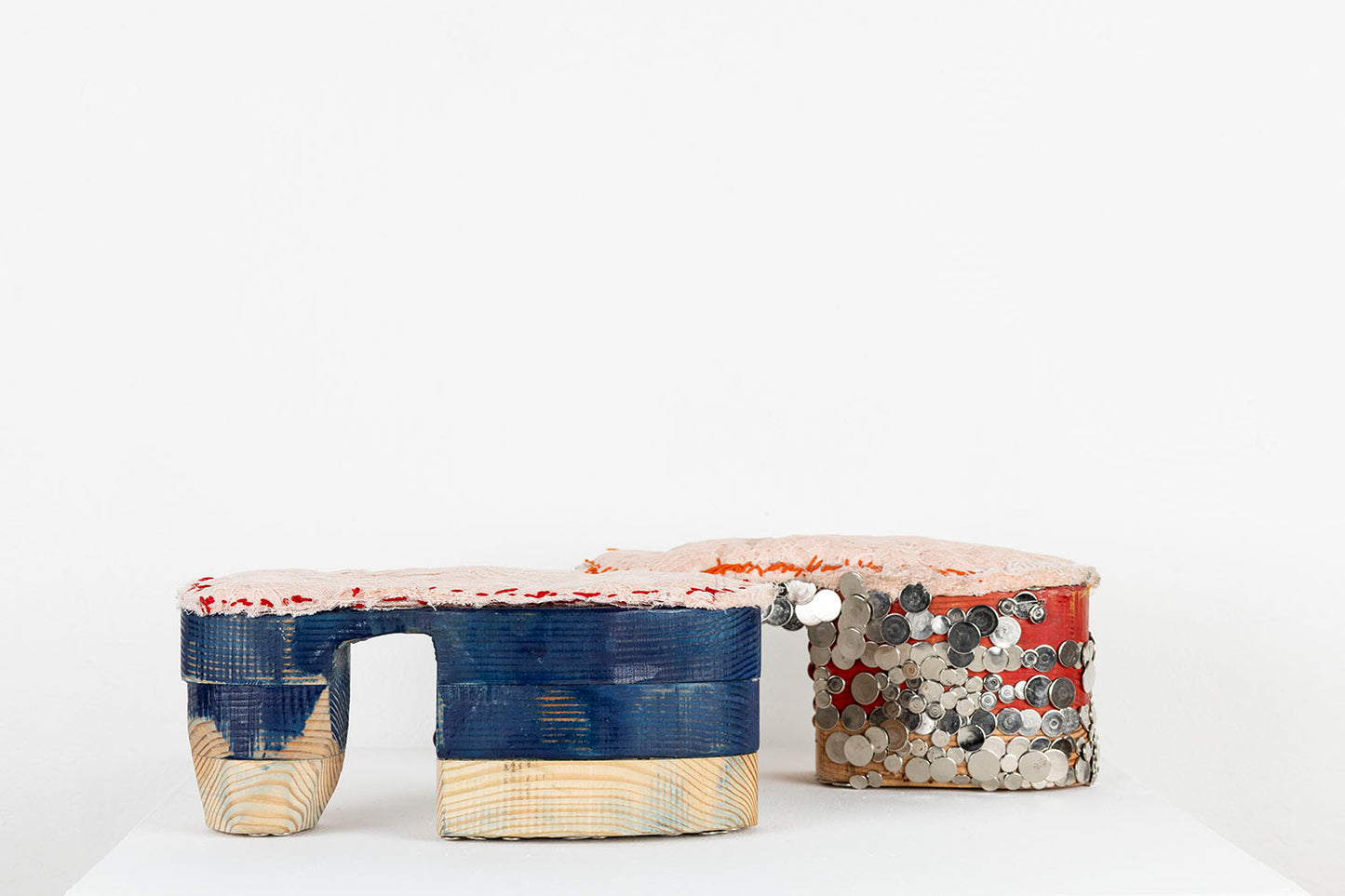 The same mixed media shoe sculpture photographed from another angle, to show the shoes in flat profile. Here the different layers of wood are in focus, as well as the dramatic shape of the tall, conical heel. 