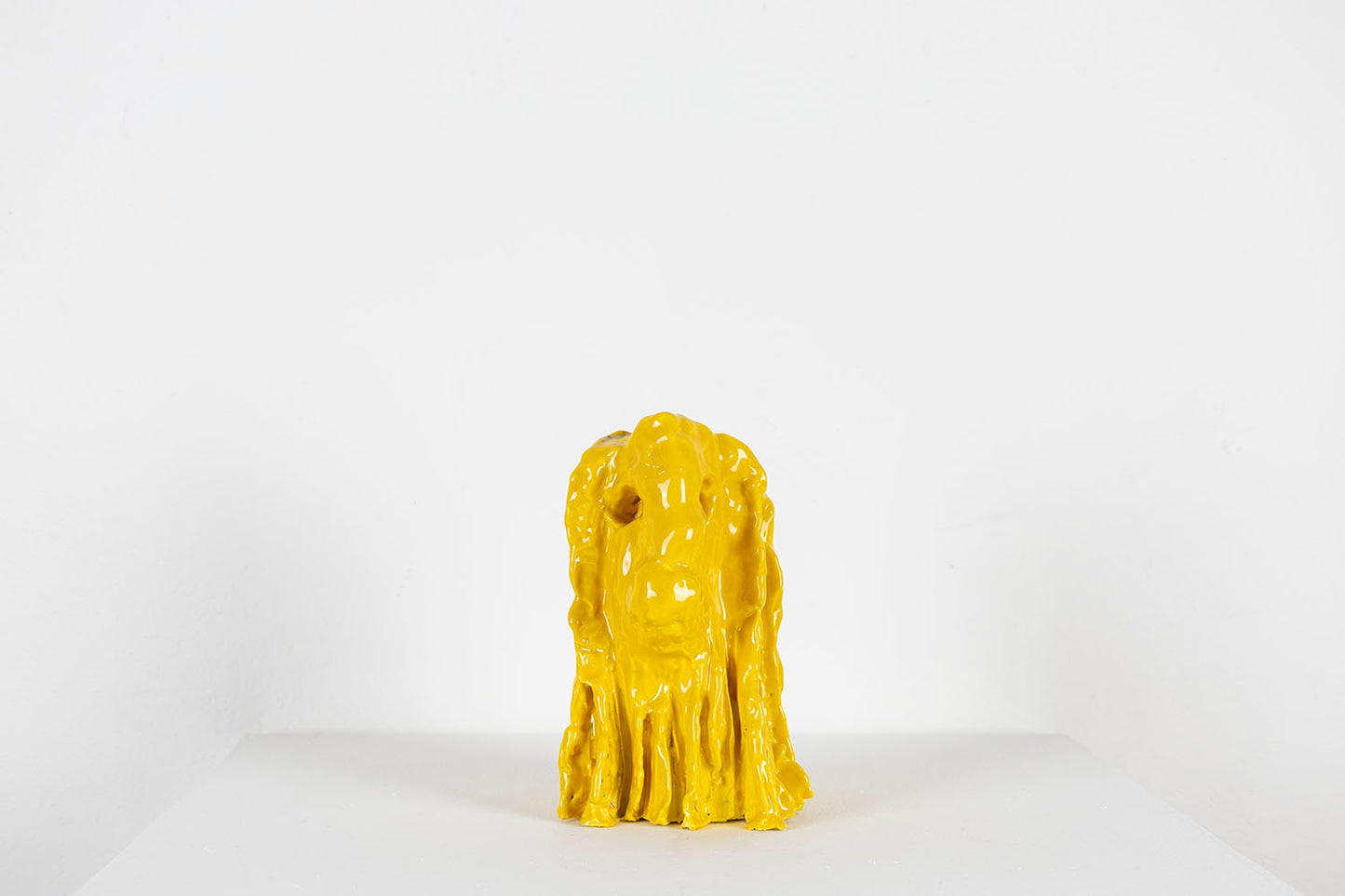 Yellow ceramic lion head on a white background