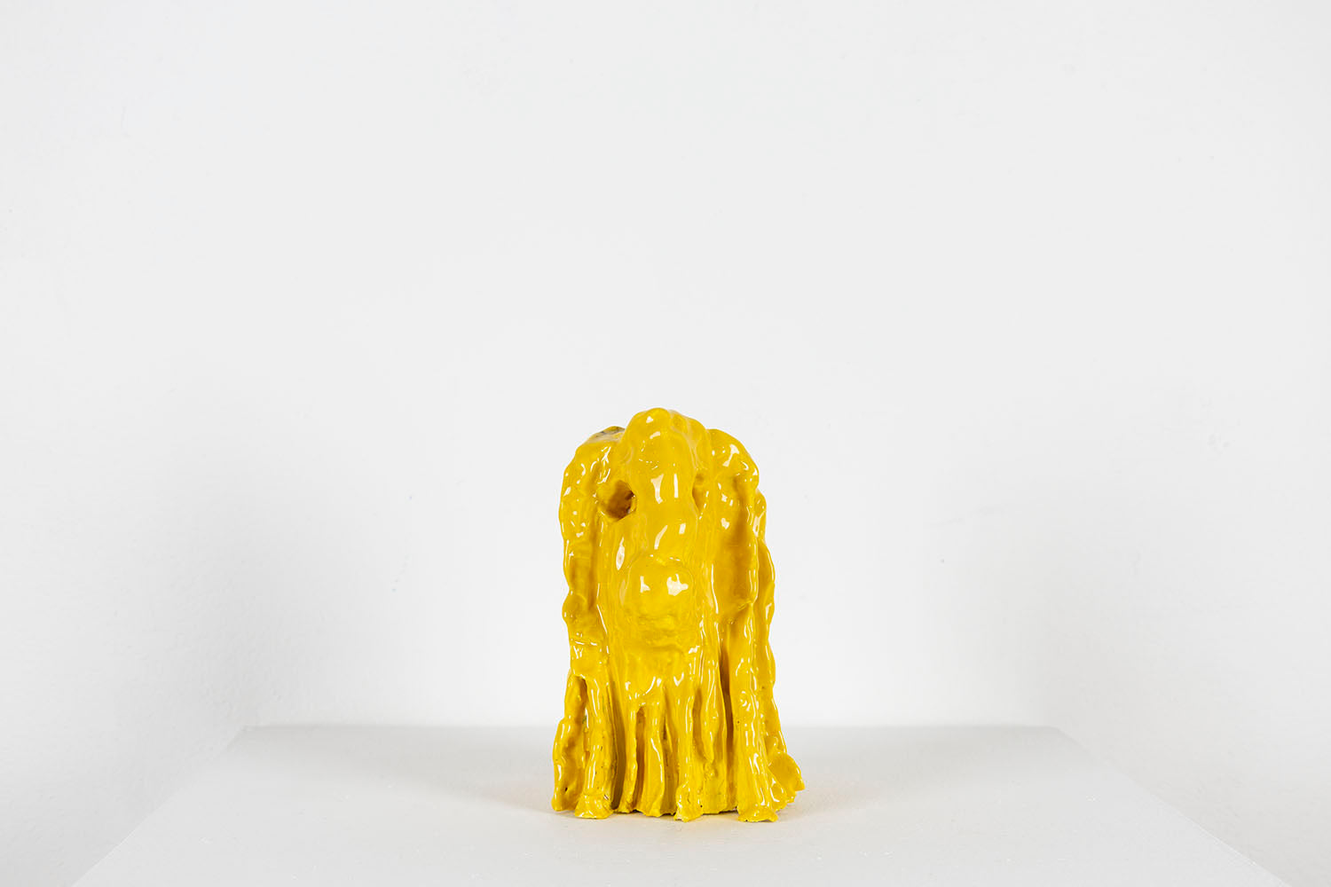 Yellow ceramic lion head on a white background