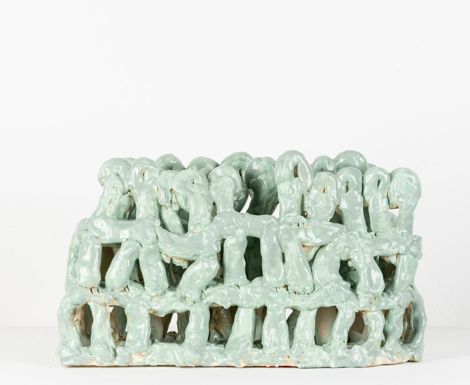 Glazed in mint green, an architectural ceramic sculpture made of three tiers of finger-sized chunks of clay.