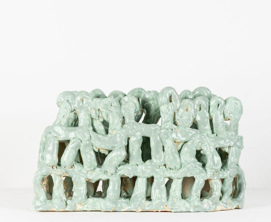 Glazed in mint green, an architectural ceramic sculpture made of three tiers of finger-sized chunks of clay.