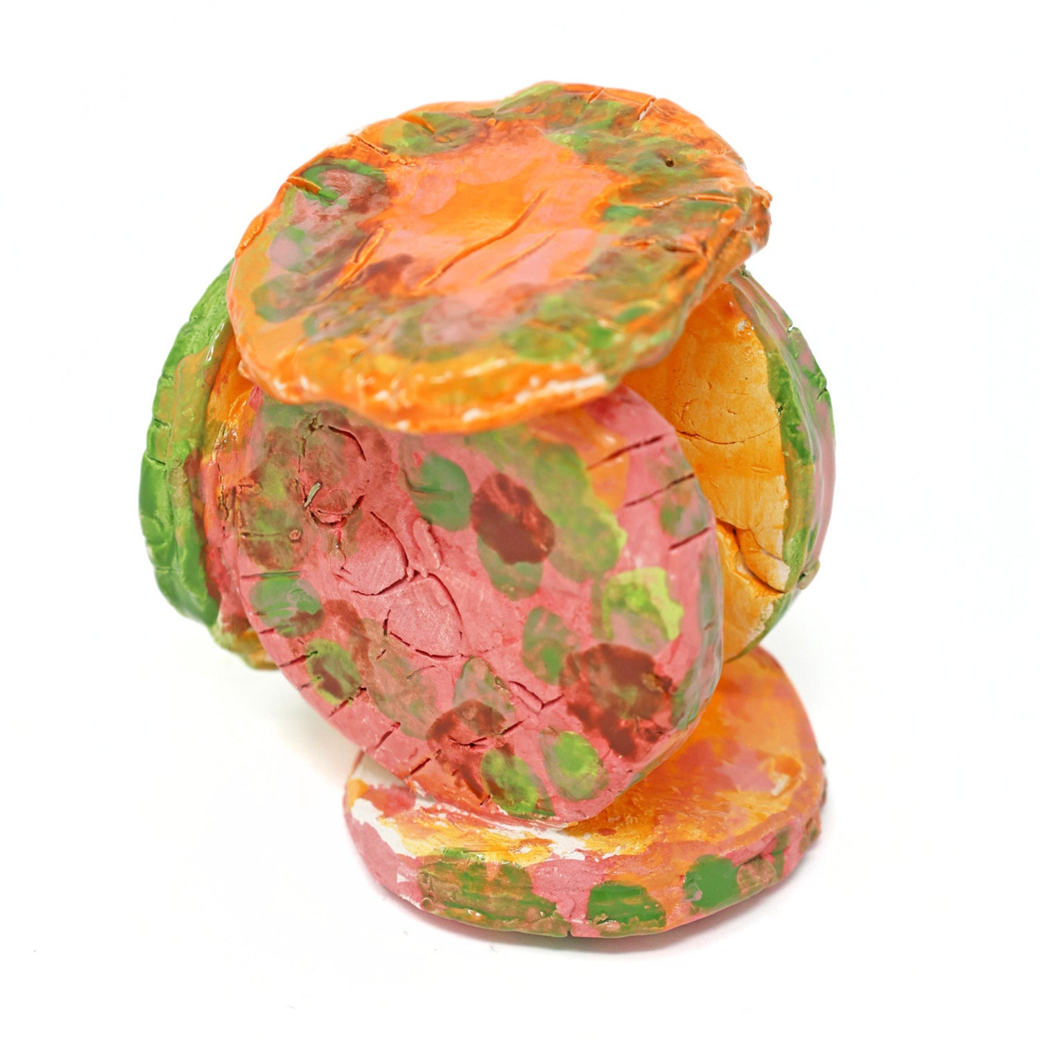 The ceramic sculpture contains 6 circles that are all connected. The piece is glazed with vibrant colors, including varying shades of green, orange and pink. There are also carved details on the face of each circle.