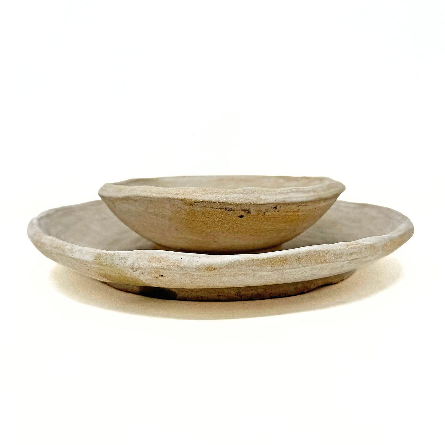 Two ceramic dishes against a white background.
