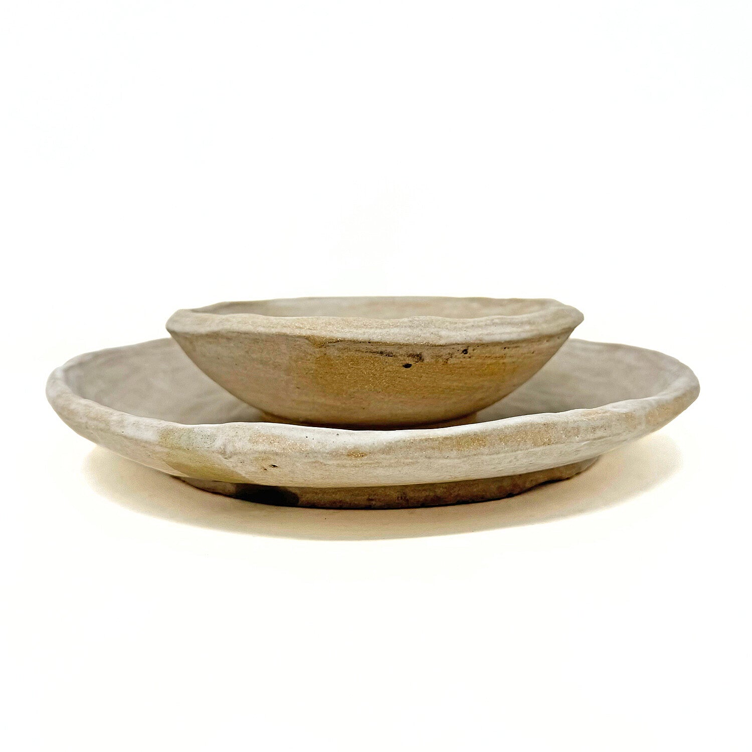 Two ceramic dishes against a white background.