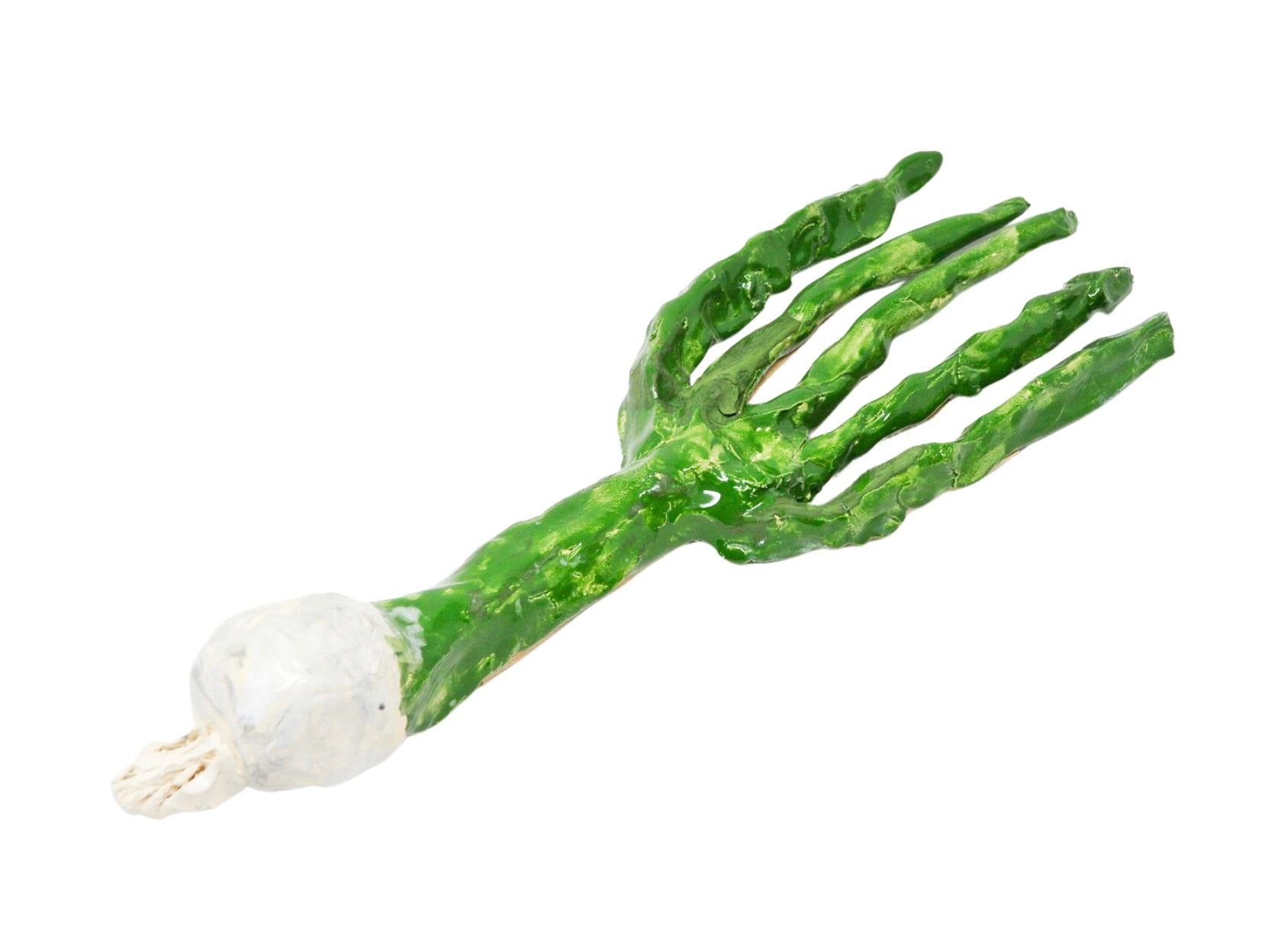 A ceramic sculpture in the shape of a green onion vegetable, glazed green and white. The object is a long green tube that branches out into 5 green stalks on one end. The other end of the sculpture is a small white colored bulb, representing the root bulb of the onion. 