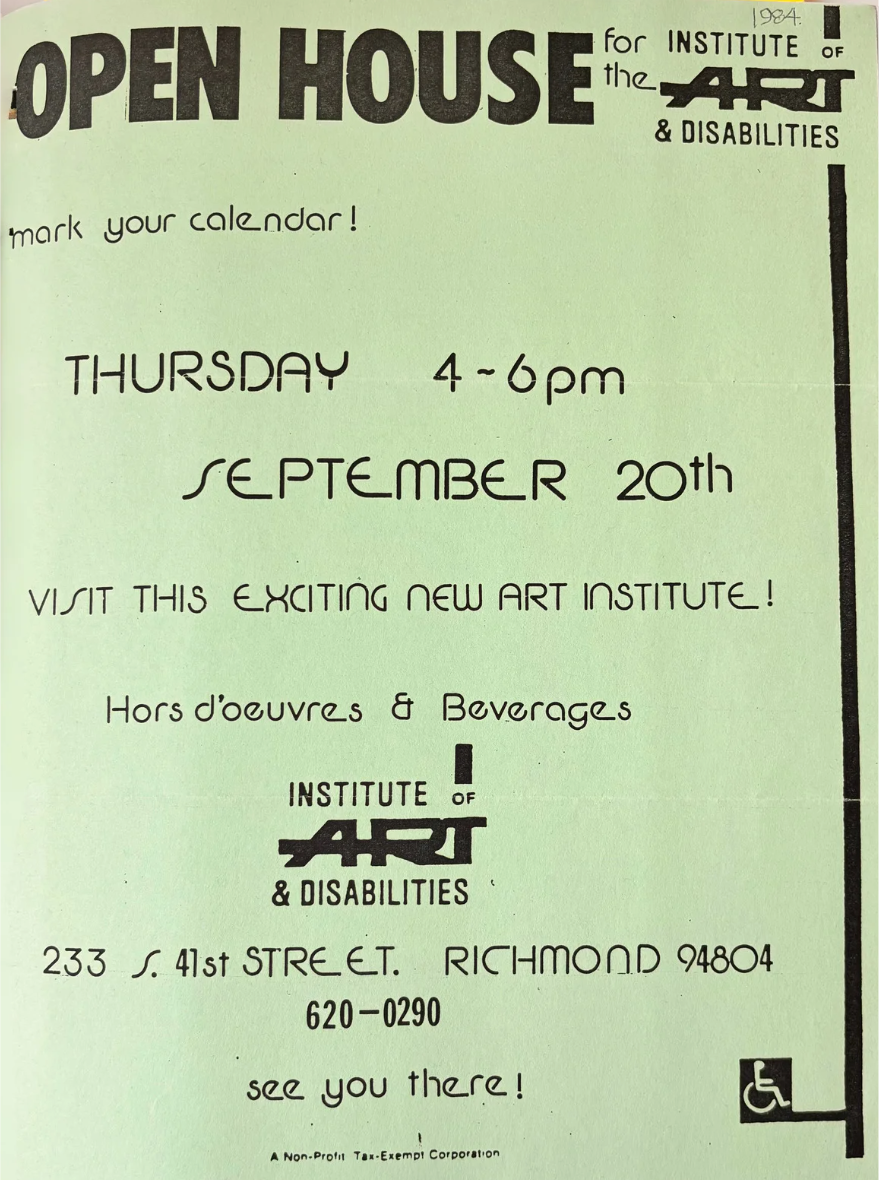 A scanned image of an old printed flier on light green paper. The flier has black text that details dates and times for an open house at the non-profit "Institute of Art & Disabilities" in 1984. There is a symbol of a person seated in a wheelchair printed in the lower right corner. 