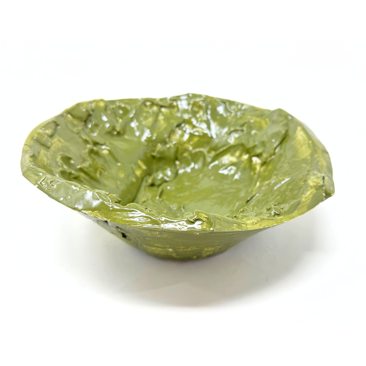 a ceramic bowl glazed all over with a shiny olive green color. The bowl was made by pressing clay into a plaster mold, so the exterior surface is smooth but the interior of the piece maintains the varied undulating texture of the artist smoothing the clay into place. 