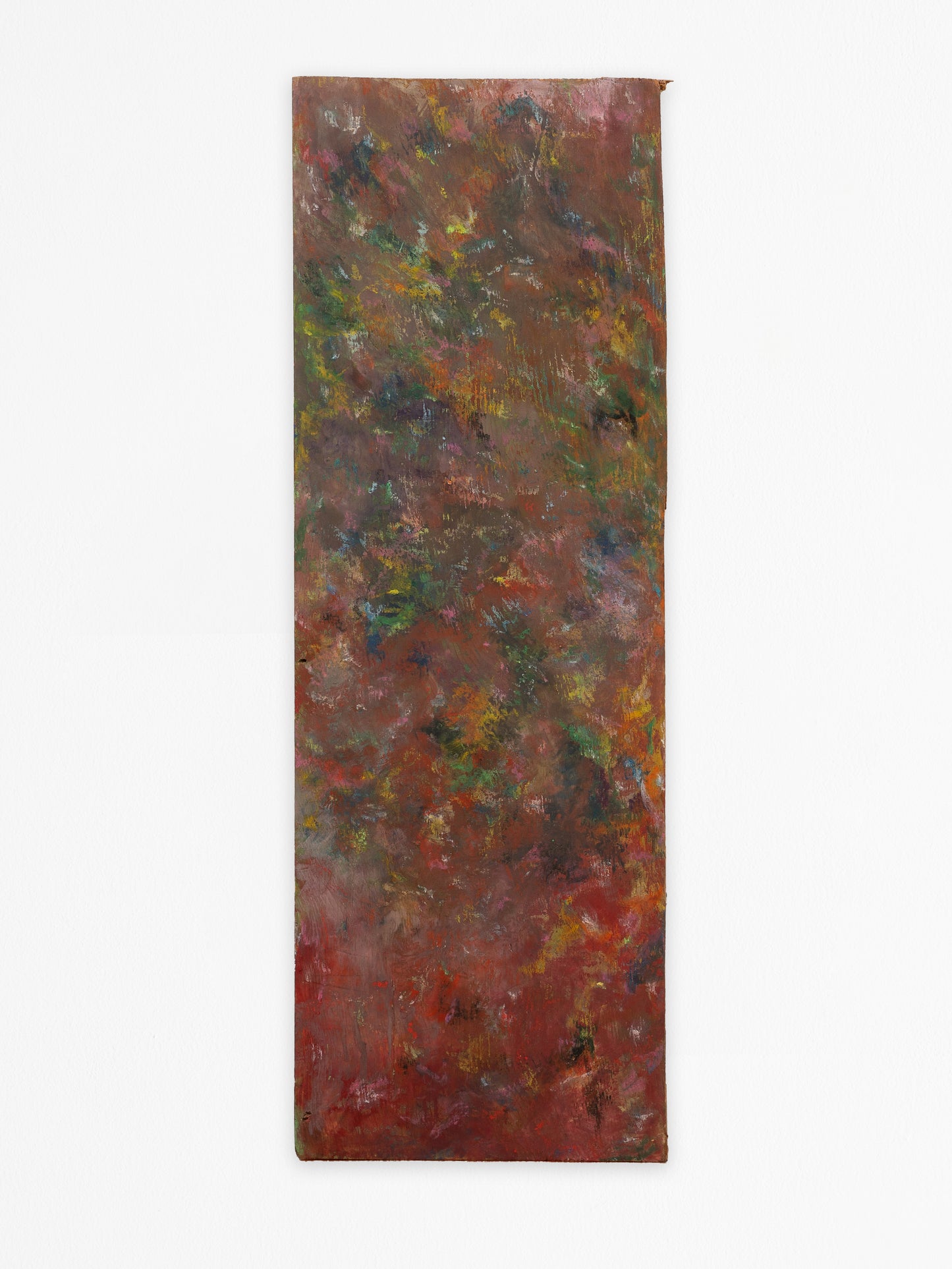 The image depicts an abstract artwork created with oil pastels and gouache on a rectangular piece of found wood. The composition is a blend of rich, earthy tones with prominent browns, reds, and greens. The colors merge into one another creating a textured surface. Strokes of yellow and hints of blue and purple add subtle highlights. The edges of the wood are rough and uneven, and the texture of the wood grain is visible beneath the layers of paint.