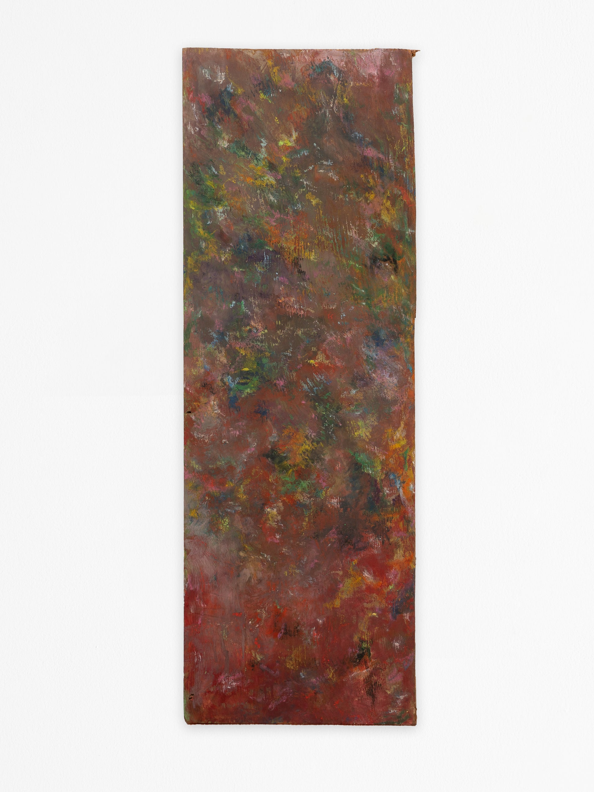 The image depicts an abstract artwork created with oil pastels and gouache on a rectangular piece of found wood. The composition is a blend of rich, earthy tones with prominent browns, reds, and greens. The colors merge into one another creating a textured surface. Strokes of yellow and hints of blue and purple add subtle highlights. The edges of the wood are rough and uneven, and the texture of the wood grain is visible beneath the layers of paint.