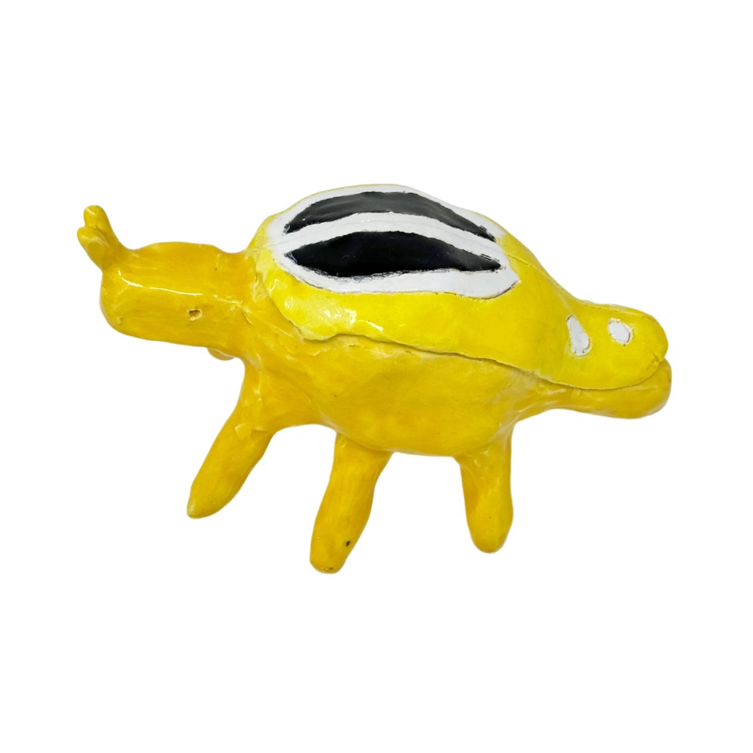 A small glazed ceramic figurine in the shape of a beetle. The form is a large round body balanced on several long tube legs. On the left, the insect has a little round head with two short antennae sticking straight up. The sculpture is glazed all over in bright yellow, with a black and white pattern on the wings. 