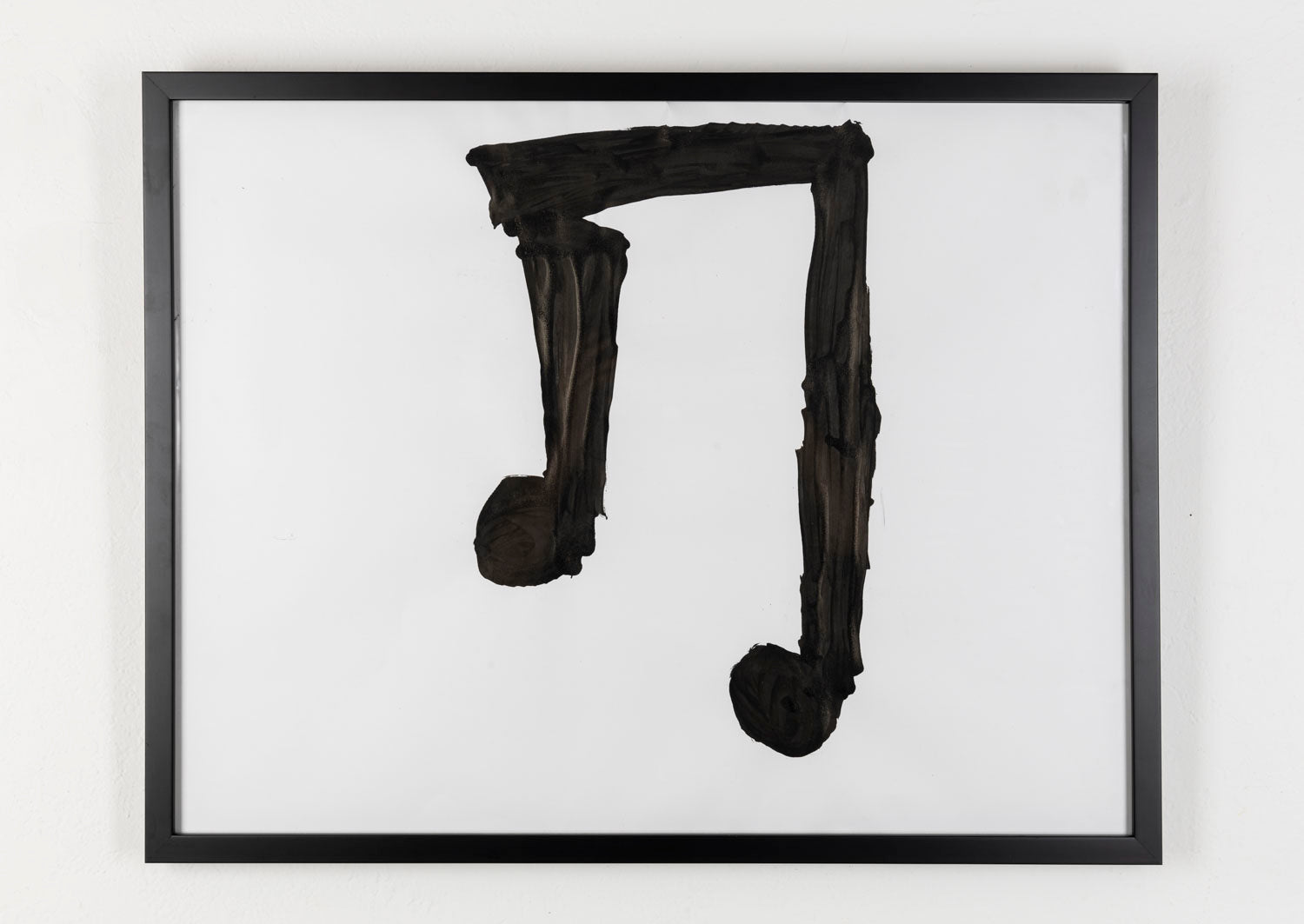 This piece is a large musical note that is painted in black against a white background.