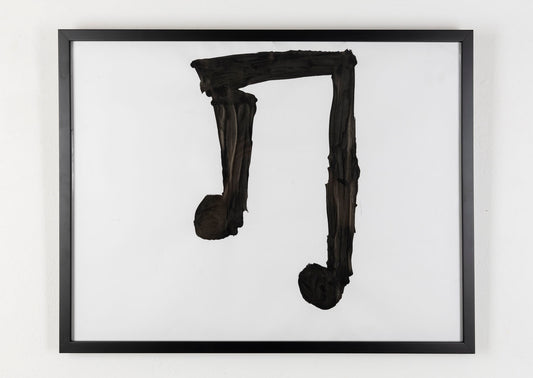 This piece is a large musical note that is painted in black against a white background.