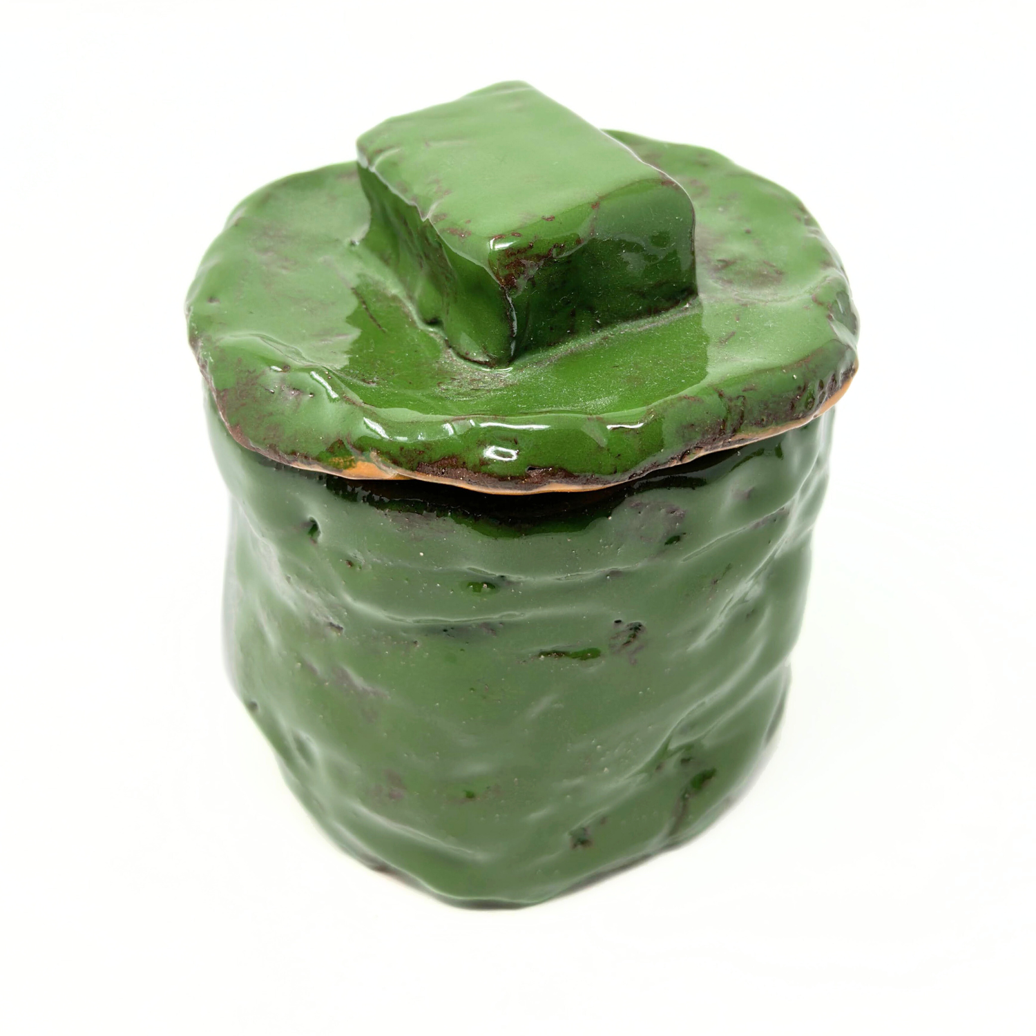 A cylindrical ceramic vessel with a round lid. The vessel is glazed all over with bright glossy green glaze. The lid has a rectangular knob. The vessel is hand built from coils and has a slightly lumpy texture where the coils were smoothed together.