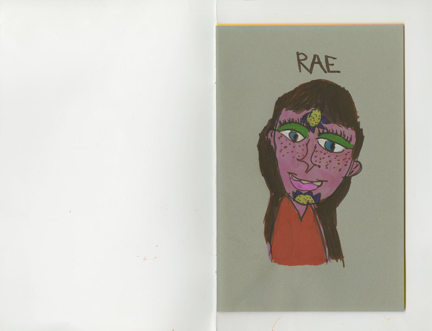 A scan of a page from the interior of the book. The page is a pale green color. A portrait of the head and shoulders of a figure is drawn in the center. The figure has pink skin, a red shirt, and long brown hair. A blue and yellow flower sprouts from the forehead and chin of the figure's face. The name "Rae" is written in black marker above the portrait. 