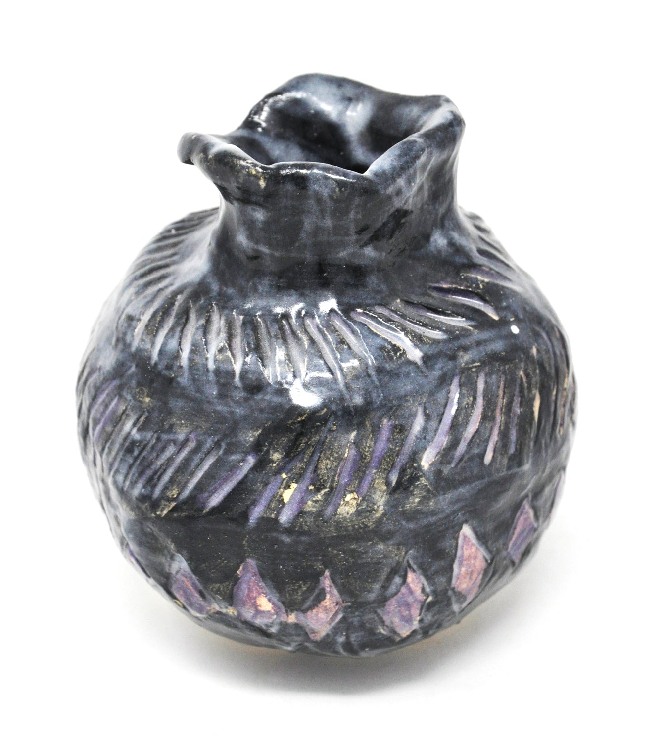 a small ceramic vessel in the shape of a round bud vase. The surface is textured with incised diamonds and dashes. The shapes are glazed purple, and the rest of the vase surface is glazed in a glossy black. 