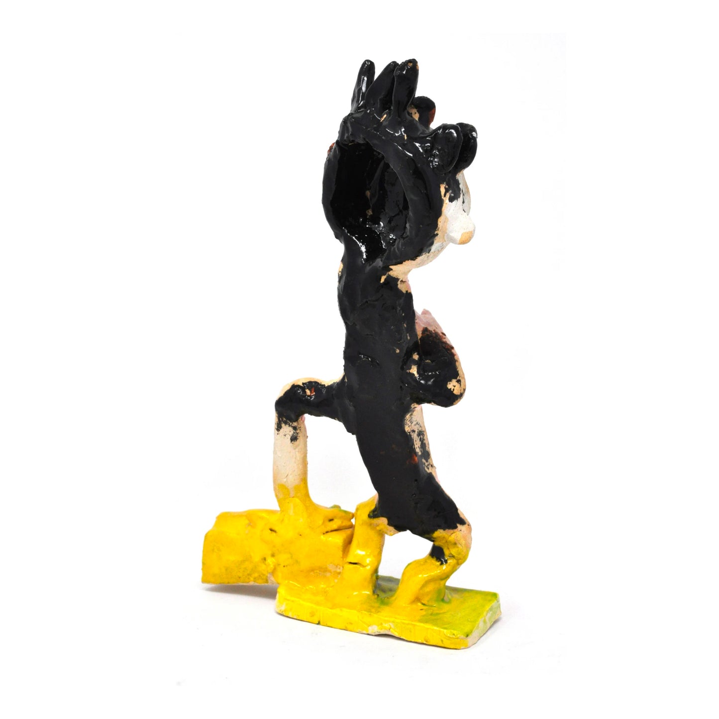 The same sculpture photographed from the back. This side of the figure is painted mostly black, with a bit of yellow glaze on the feet.  The full description is detailed in the previous images. 