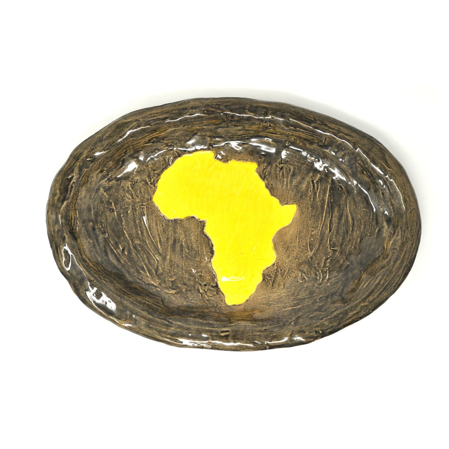 A large oval-shaped ceramic platter. In the center of the platter the artist has traced the shape of the African continent and painted it bright yellow. The rest of the platter is glazed a warm bronze color. 