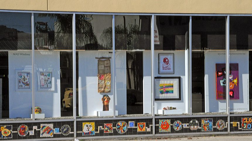 NIAD Art Centers front windows display a series of artworks by African American artists including ceramics, prints, and drawings.