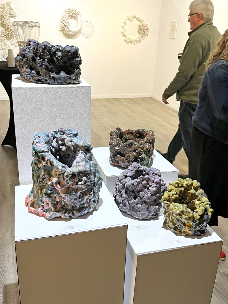 Installation view of five Peter Harris ceramic pieces on pedestals.