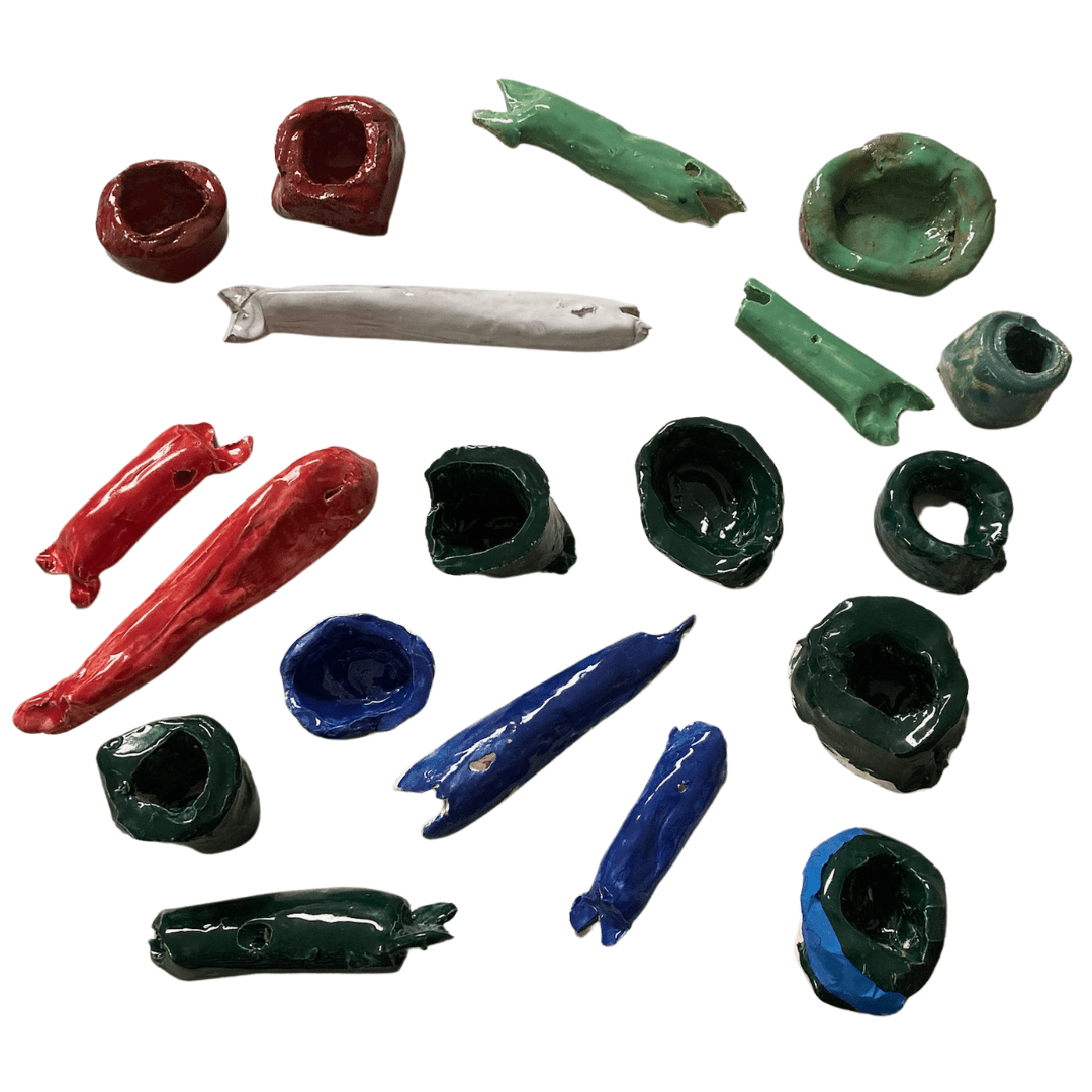 an assortment of glazed ceramics on a blank background