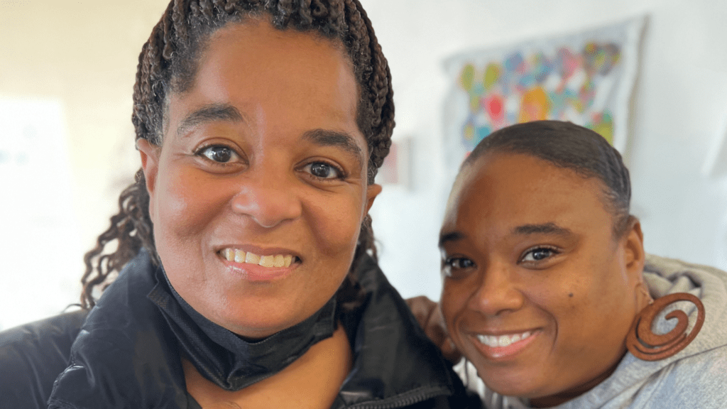 NIAD artists, Raven and Shana Harper, smile at the camera. Donate now.